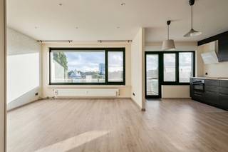 Aan de Sneeuwbeslaan 4 in Wilrijk ligt dit lichtrijke appartement op de <strong>vijfde verdieping </strong>van een appartementsgebouw met een sobere, tijdloze gevel. Het appartement heeft<strong> 2 slaapkamers</strong>, een<strong> terras</strong> en een <strong>ondergrondse autostaanplaats</strong>. Door de hoge ligging en de grote raampartijen langs meerdere zijden geniet je hier de hele dag van daglicht en van een vrij zicht over de tuinen, de hoge bomen en de skyline van de stad.<br /><br />De buurt<br />Het gebouw ligt in een groene omgeving in Wilrijk, met alles wat je dagelijks nodig hebt binnen handbereik. De <strong>supermarkt</strong> ligt naast het gebouw en in de straat zelf staat een Velo-station, zodat je met de deelfiets snel in het centrum van Antwerpen bent. De bushaltes van De Lijn, onder meer van <strong>lijn 17 en 33,</strong> liggen op wandelafstand. Met de wagen zit je in enkele minuten op de<strong> A12 en de E19.</strong><br />Opvallend in het straatbeeld is de witmarmeren<strong> Jaïntempel </strong>aan de Laarstraat. De tempel werd in India gebouwd uit blokken wit marmer, steen voor steen naar België verscheept en in Wilrijk opnieuw opgebouwd. Het is de grootste Jaïntempel buiten India. Vanop het <strong>terras </strong>heb je er een <strong>mooi zicht</strong> op.<br /><br />Dit appartement heeft een<strong> grondige facelift gekregen in 2018..<br /></strong><br />Indeling<br />Je komt binnen in een ruime inkomhal met sierlijsten aan het plafond, een ingebouwde vestiairekast, videofoon en een apart toilet. Van hieruit kijk je meteen door naar de leefruimte.<br />De leefruimte is ruim en licht. Ze heeft een lichte vloer in houtlook, inbouwspots en brede ramen langs twee zijden. De <strong>open keuken</strong> sluit hier naadloos op aan en is voorzien van alle <strong>hedendaagse comfort </strong>en veel werk- en bergruimte.<br />In het nachtgedeelte ligt de slaapkamer met een grote kastenwand, railverlichting en een raam met zicht op het groen. Een tweede kamer staat er via een open doorgang mee in verbinding. Ze is geschikt als tweede slaapkamer, als bureau of als ruime dressing. De<strong> badkamer</strong> is voorzien van een lavabomeubel, een toilet en een groot raam, wat zorgt voor veel natuurlijk licht. Enkele muren hebben nog behang, dat je eenvoudig naar eigen smaak kan aanpassen.<br /><br />Buiten<br />Zowel vanuit de leefruimte als vanuit de keuken stap je rechtstreeks het terras op. Aan de ene kant kijk je uit over de groene tuinen en hoge bomen, aan de andere kant over de daken van de buurt. Het is een fijne plek om buiten te eten of te genieten van de zonsondergang.<br />Het appartement beschikt over een <strong>ondergrondse autostaanplaats. Deze is verplicht aan te kopen aan €16.000.</strong><br /><br />Gebouw en kosten<br />Het gebouw beschikt over een lift. De gemeenschappelijke kosten bedragen ongeveer<strong> € 840 per kwartaal.</strong> Daarin zitten onder meer de <strong>verwarming</strong>, het<strong> water,</strong> de schoonmaak van de gemeenschappelijke delen, het afvalverzamelpunt, het onderhoud van de lift en de vergoeding van de syndicus.<br /><br />Troeven: 5de verdieping met vrij zicht over het groen, veel lichtinval langs twee zijden, open keuken met veel kastruimte, terras bereikbaar vanuit leefruimte en keuken, lift, ondergrondse autostaanplaats, <strong>Velo-station</strong> in de straat, supermarkt naast de deur.<br /><br /><strong>EPC: 143 kWh/m².jaar</strong><br /><br />Interesse? Contacteer ons voor een bezoek.