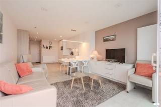 Welcome to this modern, stylish apartment in Middelkerke with direct access to the beach. This luxury landscaped property combines elegance, comfort and an exceptional seaside location.The studio features an open, bright floor plan with seamless connection between living, dining and kitchen areas. The state-of-the-art kitchen features quality appliances and countertops with everything you need for comfortable living. Divided into several rooms, you will find a full bathroom with luxury shower and modern plumbing fixtures.The interior exudes tranquility and sophistication with neutral color tones, natural materials and sophisticated finishes. Beautiful large windows and glass doors offer spectacular views of the sea and beach, while allowing maximum natural light in.The highlight is undoubtedly the expansive balcony or terrace with panoramic sea views. This is the ideal place to enjoy coastal life, watch the sunrise and soak up the sea breeze.The building has a prime location right on Middelkerke beach and offers access to excellent amenities and vibrant coastal life.Possibility to purchase pitch in the building for an additional cost of 60,000 euros.