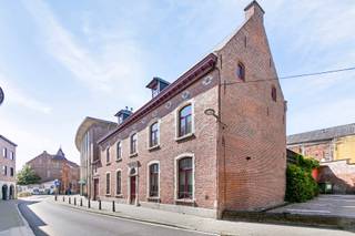 <p>Découvrez cet hôtel de maître situé en plein cœur de la ville, sur un terrain de 4a88, avec une surface habitable de 450 m². Cette demeure authentique allie charme intemporel et luxe moderne, offrant une expérience de vie unique.</p>
<p>Le bien est exempt d’amiante, dispose d’un certificat énergétique de classe D et l’installation électrique est conforme !</p>
<p>Dès l’entrée, vous êtes accueilli par un hall élégant et un vaste espace de vie avec cheminée. La maison se distingue par ses magnifiques sols en parquet et en travertin, ses hauts plafonds et ses éléments authentiques. La cuisine haut de gamme est un véritable rêve pour tout amateur de cuisine.<br />Au rez-de-chaussée, vous trouverez également un second salon et un bureau, idéal pour l’exercice d’une profession libérale.</p>
<p>Le premier étage comprend quatre chambres spacieuses, dont une suite parentale avec salle de bains attenante et accès à la terrasse sur le toit. Une deuxième salle de bains et un dressing complètent le confort.</p>
<p>Le grenier de 100 m² est entièrement aménagé en espace de vie et dispose de toutes les commodités.</p>
<p>À l’extérieur, vous profitez de plusieurs terrasses et d’un magnifique jardin avec pavillon de jardin, idéal pour des soirées d’été conviviales, des fêtes en plein air ou simplement pour se détendre dans votre propre oasis de verdure.</p>
<p>Une double place de parking à distance de marche (résidence Menegaard) est disponible en option.</p>