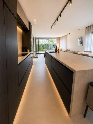 <p><strong>De luxe van een woning. Het comfort van een appartement en geen syndicuskosten!</strong></p><p>Op een rustige locatie in Vlimmeren, vlak bij Zoersel en Malle, vindt u deze uitzonderlijke gelijkvloerse woonst. Hier geniet u van de privacy, ruimte en het wooncomfort van een woning, gecombineerd met de praktische voordelen van een appartement.</p><p>Bij het binnenkomen valt meteen de kwalitatieve afwerking op. De woning werd afgewerkt met duurzame en stijlvolle materialen, waarbij travertin elementen en warme houten accenten zorgen voor een tijdloze en luxueuze sfeer. De ruime leefruimte geniet van veel natuurlijk licht en vormt samen met de open keuken het hart van de woning.</p><p>De open keuken sluit naadloos aan op de eet- en zithoek en werd ontworpen met oog voor zowel esthetiek als gebruiksgemak. Hoogwaardige toestellen, een ingebouwde wijnkoeler en doordachte opbergmogelijkheden maken van deze ruimte een aangename plaats om te koken, te genieten en gasten te ontvangen.</p><p>Aansluitend bevindt zich de sfeervolle woonkamer waar de stijlvolle bio-ethanolhaard voor extra warmte en gezelligheid zorgt. De maatwerk kastenwand met geïntegreerd tv-meubel benadrukt het strakke karakter van de woning en biedt tegelijk praktische bergruimte zonder afbreuk te doen aan het design.</p><p>Dankzij de royale leefruimte bestaat de mogelijkheid om een tweede slaapkamer te creëren zonder het wooncomfort aanzienlijk te beperken. Een eenvoudige opdeling met een lichte scheidingswand kan hiervoor een oplossing bieden. Op aanvraag kan een vrijblijvende offerte worden bezorgd zodat kandidaat-kopers een duidelijk beeld krijgen van de mogelijkheden en bijhorende investering.</p><p>De comfortabele badkamer beschikt over een inloopdouche, ligbad en dubbele lavabo. Daarnaast biedt de huidige indeling de mogelijkheid om een tweede slaapkamer te creëren, waardoor deze eigendom zich flexibel aanpast aan verschillende woonwensen en levensfases. Tegenover de badkamer bevindt zich de ruime master bedroom, een aangename en rustige ruimte waar comfort centraal staat. Dankzij de royale afmetingen is er voldoende plaats voor een volwaardig tweepersoonsbed, aanvullende kasten en een gezellige zithoek of werkruimte.</p><p>Vanuit de leefruimte heeft u rechtstreeks toegang tot het terras en de privatieve tuin, waar rust en privacy centraal staan. Dankzij de elektrische zonneluifels geniet u ook tijdens warme zomerdagen van aangename schaduw en optimaal buitencomfort. Buiten geniet u van een volledig privatief woonkarakter met een eigen garage en een ruime dubbele oprit. Hierdoor beschikt u steeds over voldoende parkeergelegenheid op eigen terrein, wat het comfort en de privacy van een klassieke open bebouwing benadert. Verplicht aan te kopen garage t.w.v. €20.000.</p><p>Ook technisch onderscheidt deze woonst zich duidelijk. Dankzij de warmtepomp van de nieuwste generatie, vloerverwarming doorheen de volledige woning, een recente boiler en een hoogwaardig ventilatiesysteem geniet u dagelijks van een uitzonderlijk wooncomfort.</p><p>Deze eigendom is ideaal voor wie op zoek is naar een gelijkvloerse woonst met tuin, een levensloopbestendige woning of een exclusieve woonomgeving waar comfort, privacy en kwaliteit centraal staan.</p><p>Troeven:</p><ul><li><p>Warmtepomp van de nieuwste generatie</p></li><li><p>Vloerverwarming doorheen de volledige woning</p></li><li><p>Recente boilerinstallatie</p></li><li><p>Hoogwaardig ventilatiesysteem voor een optimaal binnenklimaat</p></li><li><p>Hoogwaardige en duurzame materialen</p></li><li><p>Volledig gelijkvloers wonen</p></li><li><p>Privatieve inkom</p></li><li><p>Privatieve tuin en terras</p></li><li><p>Elektrische zonneluifels</p></li><li><p>16 Zonnepanelen</p></li><li><p>Garage</p></li><li><p>Ruime parkeergelegenheid op eigen terrein</p></li><li><p>Lichtrijke leefruimtes</p></li><li><p>Mogelijkheid tot creëren van een tweede slaapkamer</p></li><li><p>Volledige privacy</p></li><li><p>Levensloopbestendig wonen</p></li><li><p>Rustige ligging nabij Zoersel en Malle<br /> </p></li></ul><p>Infoplicht:<br />Vg, Wg, Gmo, Gvkr, Gvv,<br />P-score: B, G-score: B. elektriciteitsattest is conform<br />Dit is geen aanbod, alle informatie is onder voorbehoud van vergissingen of wijzigingen. Oppervlaktes zijn indicatief. </p><p><br /> </p><p><br /><br /> </p>