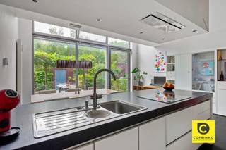 <p><span>Exceptional, newly built home in the green neighborhood of Noeveren</span></p><p><span> </span></p><p><span>In the trendy and green neighborhood </span><span>of Noeveren</span><span>, close to the new Steenbakkerijmuseum, we find this exceptional, recently built home. The centers of </span><span>Niel and Boom</span><span> are </span><span> also </span><span> just a short distance away. For nature lovers, the location is ideal: the </span><span>Nielse Kleiputten</span><span>, </span><span>De Schorre</span>,<span> and the towpath along the </span><span>Rupel</span><span> are all nearby.</span></p><p><span> </span></p><p><span> We enter the home </span><span>through the </span><span>south-facing garden</span><span>, which adjoins the garage. The dining area is immediately characterized by an impressive </span><span>two-story-high glass wall</span><span>. The loft above creates a unique sense of space and light.</span></p><p><span>Adjacent to this is the </span><span>fully equipped kitchen</span><span>. The ground floor also features a practical storage room.</span></p><p><span> </span></p><p><span>The stairwell is also exceptionally bright thanks to a window on each floor, allowing natural daylight to penetrate deep into the home.</span></p><p><span>On the first floor, at street level, we find the </span><span>spacious living room</span><span>, which is again connected to the open-plan area. From this living space, there is a beautiful visual connection to the dining area and the garden. This level also features a separate restroom with a sink and the </span><span>guest entrance</span><span>, which is accessible via a stylish walkway. An elegant glass door forms the transition between the entryway and the living room.</span></p><p><span> </span></p><p><span>One floor up are </span><span>two spacious bedrooms</span><span>, a separate restroom, and a spacious bathroom with </span><span>a bathtub and double sink</span><span>.</span></p><p><span>On the top floor is the </span><span>large master bedroom</span><span>, complemented by a second, more compact bathroom with </span><span>a walk-in shower and sink</span><span>. Behind the bathroom is a separate utility room.</span></p><p><span>This home combines </span><span>contemporary architecture, exceptional natural light, generous spaces, and an excellent location</span><span> in a green and increasingly attractive neighborhood.</span></p><p><span> </span></p><p><span>Details:</span></p><ul><li><span>16-  solar panels with green certificates </span></li><li><span>South-facing garden</span></li><li><span>Attached garage</span></li><li><span>Impressive two-story glass wall</span></li><li><span>Loft with a spacious feel</span></li><li><span>3 spacious bedrooms</span></li><li><span>2 bathrooms</span></li><li><span>Fully equipped kitchen</span></li><li><span>Practical storage areas</span></li><li><span>Energy-efficient, recently built home (EPC A rating)</span></li><li><span>Located in trendy Noeveren, close to the Steenbakkerij Museum</span></li><li><span>Nature and recreation nearby, including the Nielse Kleiputten, De Schorre, and the Rupel</span></li></ul><p><span> </span></p>