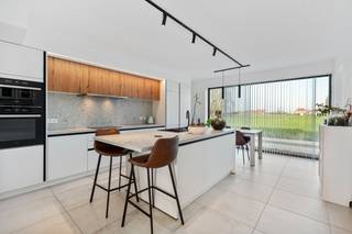 <ul>
	<li>Deze <strong>lichtrijke en moderne rijwoning </strong>bevindt zich in het hart van Baarle, op wandelafstand van een crèche, kleuter- en lagere school, de bakker en de slager.</li>
	<li>Geniet van de <strong>groene omgeving,</strong> met <strong>de Leie</strong> op slechts vijf minuten wandelafstand. De E40 is vlot bereikbaar met de wagen.</li>
	<li><u><strong>Indeling</strong></u>: inkomhal met vestiaire, gastentoilet, keuken, 2 bergingen en een mooie lichtrijke leefruimte met een grote tuin. Op de verdieping bevinden zich drie volwaardige slaapkamers, een badkamer met inloopdouche, bad en een toilet.</li>
	<li><strong>Parkeerplaats (€15.000) dienen verplicht bijkomend aangekocht te worden.</strong></li>
	<li>In de tuin vindt u <strong>een ruim terras en een tuinhuis</strong>. De tuin is ook bereikbaar via een achterliggend wegeltje.</li>
	<li>De volledige woning wordt verwarmd via <strong>vloerverwarming</strong>, aangestuurd door een <strong>warmtepomp.</strong> Daarnaast zijn er <strong>6 zonnepanelen</strong> aanwezig. <strong>E-peil: 14.</strong></li>
	<li>Verder beschikt de woning over een volledig geïntegreerd domoticasysteem dat de verlichting, rolluiken en zonnewering aanstuurt.</li>
</ul>