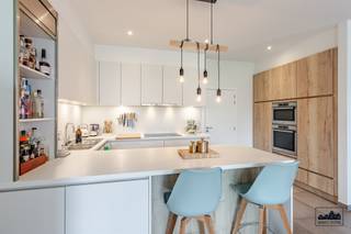 <p>Bent u op zoek naar een ruim en luxueus afgewerkt appartement met 2 slaapkamers, meerdere terrassen én een topligging in het hart van Sint-Niklaas? Dan is dit appartement absoluut een bezoek waard!</p><p>U betreedt het app via een private buitentrap en komt zo in de ruime inkomhal met ingemaakte kasten. Vanuit hier bereikt u de lichtrijke leefruimte met een prachtig open zicht op de binnentuin. De leefruimte is voorzien van een stijlvolle open keuken met aanpalende berging.</p><p>De keuken is uitgerust met alle nodige toestellen: een ingebouwde inductiekookplaat, dampkap, dubbele spoelbak, koelkast, diepvries, vaatwasser, heteluchtoven en microgolfoven. De toegang tot de leefruimte verloopt via een elegante glazendeur, wat zorgt voor een extra luxueuze uitstraling.</p><p>Verder in de hal vindt u 2 ruime slp, beiden met de mogelijkheid tot het plaatsen van een dubbel bed. Eén van de slaapkamers beschikt over een terras van 4,5 m² (oost-west gericht) en een ingemaakte kast. De badkamer (7 m²) is stijlvol ingericht met een comfortabele inloopdouche voorzien van inbouwkraan en regendouche, dubbele wastafel, handdoekradiator en toilet. Daarnaast is er nog een apart gastentoilet aanwezig.</p><p>Het appartement voelt extra ruim dankzij de bewoonbare oppervlakte van maar liefst 123 m², de praktische indeling én de hoge plafonds van 2,8 meter. Er is voldoende bergruimte aanwezig en het hele appartement is voorzien van vloerverwarming op aardgas. De PVC-ramen zijn uitgerust met spiegelglas en vliegenramen, en er is een ventilatiesysteem type C.</p><p>Het appartement maakt deel uit van een afgesloten woonerf met uitzicht op een gezellige, centrale tuin. Er is een laad- en loszone, een ondergrondse afvalruimte, laadpaal voor elektrische voertuigen, zonnepanelen voor de gemeenschap en een fietsenstalling. Dankzij het gesloten hekwerk is privacy gegarandeerd.</p><p>Bij het appartement is een garagebox aanwezig, deze kan mee aangekocht worden voor 35.000,00 euro.</p><p>Troeven:<br />- garagebox voor 2 wagens<br />- ruime bewoonbare oppervlakte<br />- hoge plafonds<br />- rustige ligging<br />- E-peil E68</p><p>Heeft u interesse in dit unieke appartement? Neem dan snel contact met ons op via margot.raemdonck@immo-zone.be of bel naar 0473 51 80 58.</p>