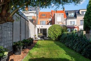 Welkom in deze verrassend ruime en volledig gerenoveerde gezinswoning, gelegen in een rustige, verkeersarme straat nabij het centrum van Schoten. Hier geniet u van een aangename residentiële woonomgeving, waar rust en een uitstekende bereikbaarheid hand in hand gaan.<br />De ligging tussen het centrum en de vaart biedt het beste van twee werelden. Winkels, scholen, supermarkten en andere dagelijkse voorzieningen bevinden zich op korte afstand. Ook natuurliefhebbers komen hier aan hun trekken, met het Gemeentepark, Park Vordenstein en diverse wandel- en fietsmogelijkheden in de nabije omgeving.<br /><br />Indeling van de woning:<br />Via de inkomhal met vestiaire, waar eventueel een gastentoilet kan worden ingericht, betreedt u de woning. De gezellige leefruimte op parketvloer omvat een aangenaam salon met haard en een aparte bureauhoek.<br />Aansluitend bevindt zich de ruime open leefkeuken, uitgerust met alle nodige toestellen, een stijlvol werkblad in blauwe hardsteen en een praktische eet(- en ontbijt)hoek. Dankzij het grote schuifraam geniet u hier van een mooie lichtinval en een directe verbinding met de tuin.<br />Verder beschikt het gelijkvloers over een badkamer met ligbad en inloopdouche met infraroodfunctie, evenals een afzonderlijke bijkeuken en wasruimte.<br /><br />Eerste verdieping:<br />Via de trap bereikt u de nachthal op de eerste verdieping. Hier bevinden zich twee aangename slaapkamers, waarvan de grootste aan de voorzijde van de woning ligt. <br />Beide kamers zijn afgewerkt met een karaktervolle plankenvloer.<br /><br />Tweede verdieping:<br />De vaste trap brengt u naar de volledig ingerichte zolderverdieping. Hier bevinden zich nog eens twee slaapkamers, beiden voorzien van praktische maatkasten.<br />De kleinere slaapkamer beschikt over een toilet en biedt bovendien de mogelijkheid om een tweede badkamer te creëren. <br />Een interessante troef voor grotere gezinnen of wie extra comfort wenst.<br /><br />Buitenruimte:<br />De zonnige, zuidwestgerichte tuin vormt een heerlijke plek om te ontspannen. Het aangename terras met zonnetent aan de achtergevel nodigt uit om volop van het buitenleven te genieten. Achteraan bevindt zich een praktische tuinberging.<br /><br />Parkeren:<br />Aan de voorzijde beschikt de woning over een verharde voortuin, die momenteel als parkeerplaats wordt gebruikt.<br />Daarnaast bestaat de mogelijkheid om de huurovereenkomst van een garagebox in een garagecomplex aan de overkant van de woning (op ongeveer 50 meter) over te nemen.<br /><br />Kelder:<br />Via een toegangsluik in de inkomhal bereikt u de droge kelder. Hier bevinden zich de nutsmeters en is er extra bergruimte voorzien.<br /><br />Troeven van de woning:<br />- Volledig instapklaar en grondig gerenoveerd tussen 2016 en 2019<br />- Vier volwaardige slaapkamers<br />- Gezellige leefruimte met haard en bureauhoek<br />- Ruime open leefkeuken<br />- Zonnige zuidwestgerichte tuin met terras en zonnetent<br />- Mogelijkheid tot tweede badkamer<br />- Energiezuinig B-label<br />- Vernieuwd en geïsoleerde plat dak (2012)<br />- Geïsoleerde achtergevel (2019) en condensatieketel (2016)<br />- Conforme elektrische installatie<br />- Droge kelder en praktische tuinberging<br />- Mogelijkheid tot overname huur garagebox<br />- Rustige ligging nabij het centrum van Schoten en de vaart<br /><br />Kortom:<br />Deze verrassend ruime gezinswoning combineert een warme uitstraling met hedendaags wooncomfort. Dankzij de grondige renovatie, vier slaapkamers, praktische indeling en aangename zuidwesttuin is dit een ideale thuis voor gezinnen die comfortabel willen wonen zonder grote renovatiewerken.<br />Bovendien zorgen het energiezuinige B-label en de uitstekende ligging nabij het centrum van Schoten voor een mooie meerwaarde.<br />Een instapklare gezinswoning waar ruimte, gezelligheid en energiezuinig wonen samenkomen. <br /><br />Overtuig uzelf tijdens een bezoek ter plaatse!