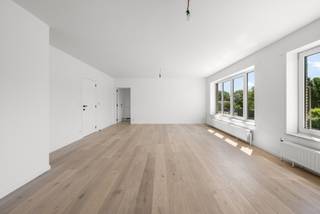 Dit totaal gerenoveerde appartement, centraal gelegen aan de Gentsesteenweg te Asse, combineert ruime leefvolumes met een hoogwaardige en hedendaagse afwerking. Dankzij de grondige renovatie is het appartement volledig instapklaar en vormt het een ideale woonst voor wie op zoek is naar comfort, ruimte en kwaliteit.

Bij het betreden van het appartement komt u terecht in de inkomhal, die toegang biedt tot een apart gastentoilet en de volledig vernieuwde badkamer. Aan de rustige achterzijde van het gebouw bevinden zich twee ruime slaapkamers, die dankzij hun ligging een aangename en rustige nachtomgeving bieden.

De absolute blikvanger is de royale leefruimte van maar liefst 35 m², waar voldoende plaats is voor zowel een volwaardige salon- als eetkameropstelling. Aansluitend bevindt zich de volledig vernieuwde keuken van circa 10 m², uitgerust met alle hedendaags comfort en afgewerkt met kwalitatieve materialen. De combinatie van de ruime leefruimte en moderne keuken zorgt voor een bijzonder aangename woonbeleving.

Het volledige appartement werd met veel aandacht voor detail gerenoveerd, waarbij gekozen werd voor hoogwaardige materialen en een tijdloze afwerking. Hierdoor kan de nieuwe eigenaar zonder verdere werken zijn intrek nemen.

Een belangrijke extra troef is de privatieve garage met sectionaalpoort, die bovendien reeds inbegrepen is in de verkoopprijs. Een comfortabel, volledig gerenoveerd appartement met twee ruime slaapkamers, royale leefruimte en eigen garage op een gunstige locatie in Asse.
Meer info of een bezoek: Michael@immoaccenta.be