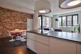 This luxury apartment with industrial accents is located in an old toy factory in Mortsel where old and new elements are interwoven.Living room and...