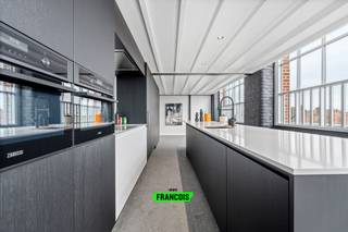 Op de tweede verdieping, in het voormalig fabriekspand "De Groote Fabrieke", treffen we deze hoogwaardig afgewerkte loft. De loft combineert de nieuwste technieken met behoudt van authentieke elementen. <br /><br />De indeling is als volgt. Via de inkomhal, met ingemaakte kasten en een apart gastentoilet, betreden we de grote open keuken. De keuken is voorzien van alle toestellen en biedt via een verborgen deur toegang tot een ruime berging (15 m²). Aansluitend aan de keuken is er de grote, lichtrijke, woonkamer en het terras (25m²) dat volop rust en privacy biedt.<br /><br />Op de tweede verdieping biedt de loft nog 2 volwaardige slaapkamers met elk een eigen badkamer. <br /><br />Er is ook de mogelijkheid tot de aankoop van een autostaanplaats met extra berging. <br /><br />Wenst u meer informatie of een bezoek? Aarzel dan niet om contact op te nemen via Ruben: 0479/60.36.94. <br /><br />