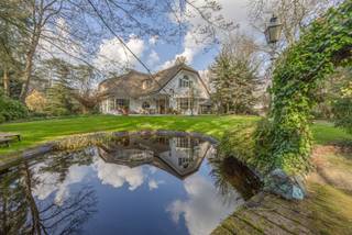 <p>Deze ruime en degelijk gebouwde villa combineert comfort, karakter en een uitzonderlijk gevoel van ruimte. De woning is <strong>residentieel gelegen</strong> in een rustige omgeving en geniet bovendien van een <strong>gunstige ligging ten opzichte van de E34 (Antwerpen – Eindhoven)</strong>, waardoor belangrijke verbindingswegen vlot bereikbaar zijn. De woning werd steeds zorgvuldig onderhouden en biedt een <strong>zeer solide basis</strong>, gebouwd met <strong>kwalitatieve en duurzame materialen</strong>. Op het gelijkvloers zorgen <strong>prachtige vloeren en parketvloeren</strong> voor een warme en stijlvolle uitstraling.</p>
<p>Bij het betreden van de woning wordt u verwelkomd in een royale <strong>inkomhal met vestiairekast en gastentoilet</strong>. Aansluitend bevindt zich een <strong>bureel</strong>, ideaal voor thuiswerk of een rustige werkplek. Vanuit de inkomhal bereikt u de lichtrijke leefruimtes die mooi in elkaar overlopen.</p>
<p>De ruime <strong>living</strong> biedt een aangename zithoek rond de open haard en geniet van grote raampartijen die zorgen voor een overvloed aan natuurlijk licht en een mooi zicht op de tuin. Aansluitend bevindt zich de <strong>eetkamer</strong>, die perfect geschikt is voor gezellige diners en het ontvangen van gasten.</p>
<p>Een absolute troef van deze woning is de <strong>prachtige tuinkamer</strong>, een bijzonder lichtrijke ruimte die kan ingericht worden als extra zitkamer, eetkamer of ontspanningsruimte. Dankzij de grote raampartijen geniet u hier van <strong>mooie zichten op de tuin</strong> en heeft u <strong>rechtstreekse toegang tot het ruime zonneterras</strong>, waardoor binnen en buiten naadloos in elkaar overlopen.</p>
<p>De <strong>keuken</strong> vormt het hart van de woning en beschikt over voldoende werk- en bergruimte. Praktisch ingedeeld met een <strong>handige bijkeuken én een koele berging</strong>, biedt deze ruimte alle comfort voor het dagelijkse gebruik.</p>
<p>Op de verdieping bevinden zich <strong>vier volwaardige slaapkamers</strong> en <strong>drie badkamers</strong>, wat zorgt voor een comfortabele indeling voor het hele gezin. <strong>Twee van de slaapkamers beschikken bovendien over een eigen terras</strong>, waardoor u ook hier kan genieten van een aangename buitenruimte. De <strong>masterbedroom</strong> vormt een echte privésuite en beschikt over een <strong>inloopdressing</strong> en een <strong>riante badkamer met sauna</strong>, wat zorgt voor extra comfort en ontspanning.</p>
<p>Rondom de woning bevinden zich <strong>riante terrassen</strong>, waardoor u op elk moment van de dag kan genieten van rust en privacy.</p>
<p>Een bijzondere troef van deze eigendom is de <strong>zeer ruime garage</strong> met plaats voor <strong>drie wagens</strong> en bijkomende opslagruimte. Boven de garage bevindt zich bovendien een <strong>riante polyvalente ruimte</strong> die perfect kan worden ingericht als <strong>guesthouse, hobbyruimte, kantoor of stijlvolle bar</strong>.</p>
<p>Voor het gemak van onze kandidaat-kopers hebben wij in deze presentatie enkele ruimtes visueel geoptimaliseerd. Zo werden de muren neutraal geschilderd en werden op bepaalde plaatsen meubels vervangen door een moderne inrichting. Dit geeft een duidelijk beeld van de hedendaagse mogelijkheden en het potentieel van de woning.</p>
<p>Kortom, een uitzonderlijke eigendom die ruimte, comfort en mogelijkheden combineert op een uitstekende locatie.</p>
<p>Contacteer ons gerust voor bijkomende informatie of een bezoek ter plaatse.</p>