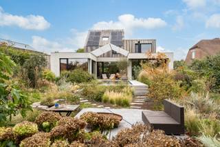 Deze stijlvolle villa, verbouwd en uitgebreid sinds 2020 tot heden, combineert luxe en functionaliteit in een serene omgeving. Ondanks de rustige ligging zijn alle nodige voorzieningen zoals winkels, openbaar vervoer, scholen en eetgelegenheden vlot bereikbaar.<br /><br />Indeling:<br />Bij het binnenkomen in de ruime inkomhal met wachtruimte heeft u onmiddellijk toegang tot de praktijkruimte, de technische ruimte en een gastentoilet. Vanuit de hal bereikt u het privégedeelte van de woning, met een eetkamer, bureau of speelhoek, een gezellige zitruimte met stijlvolle hangende open haard en een ruime, moderne leefkeuken. Aansluitend aan de keuken bevindt zich een praktische berging en wasplaats, die rechtstreeks verbonden zijn met de privé-ingang via de carport.<br /><br />De grote ramen op de benedenverdieping zorgen voor een overvloed aan natuurlijk licht en bieden een prachtig zicht op de idyllische tuin.<br /><br />Via de speelhoek/bureau leidt een trap naar de eerste verdieping, waar een badkamer met inloopdouche, wastafel en toilet is ondergebracht, evenals drie ruime slaapkamers. De master bedroom beschikt bovendien over een eigen dressing en een in te richten badkamer, voorzien van ruimte voor een dubbele wastafel, inloopdouche en toilet.<br /><br />In de nachthal brengt een vaste trap u naar de tweede verdieping, waar een vierde ruime slaapkamer van maar liefst 35 m² is gelegen. Deze ruimte is groot genoeg om desgewenst eenvoudig op te splitsen in twee aparte slaapkamers.<br /><br />Daarnaast bestaat de mogelijkheid om de praktijkruimte in te richten als zesde slaapkamer.<br /><br />Buitenruimte:<br />De tuin biedt een oase van rust en ruimte met een groot overdekt terras dat uitzicht geeft op de infinity-zwemvijver. Verder in de tuin vinden we een tweede vijver met een apart terras, en een derde terras waar u kunt loungen in volledige privacy.<br /><br />Energiezuinig:<br />De woning heeft een gunstig EPC-label A dankzij onder andere 24 zonnepanelen (8.520 Wp), een nieuwe condenserende gasketel (2021), volledige isolatie, HR-glas en andere energiebesparende voorzieningen.<br /><br /><br />Voor meer informatie over deze unieke parel of wenst u een bezichtiging in te plannen, neem contact met ons op via info@vastengoed.be of bel naar 014/72 73 74.<br /><br />(Wenst u een gratis schatting van uw eigendom? Neem contact met ons op via 014/72 73 74.)