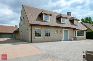 Instapklare lichtrijke villa, afgeschermd door omheining en hagen. Bestaande uit een inkomhall, vestiaire, grote lichtrijke living, ingerichte keuken met eet- en zitruimte, wasplaats, 5 slaapkamers, hobbyruimte, dressing, 2 badkamers, zolder, kelder. Garage voor 2 wagens