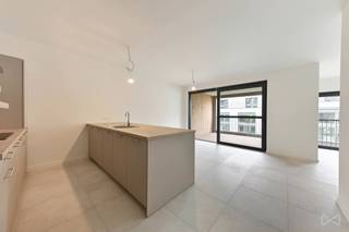 This energy-efficient new-build flat forms part of the prestigious Burenberg residential development in Leuven, a green and peaceful area within walking distance of the city centre and close to major access roads. <br /><br />This move-in-ready flat combines modern comfort, the latest technology and a practical layout with high-quality finishes.<br />The showpiece of the flat is the light-filled living area with open-plan kitchen. The large sliding window opens onto the spacious covered terrace, which leads onto a south-facing communal garden. The kitchen, featuring a cooking island, is fully fitted and thoughtfully finished with warm materials; there is also a utility room with a connection for a washing machine.<br /><br />The central hallway provides access to all other rooms in the flat. In addition to the two full-sized bedrooms, there is a separate toilet and a bathroom with a spacious walk-in shower. Here too, comfort is combined with attractive material choices and fine details such as indirect lighting.<br /><br />From the underground car park, you can take the lift directly to the apartment block. The parking space is available to rent for €100.<br /><br />In short, this apartment ticks all the boxes for anyone looking for a lovely place where high-quality living is combined with a central yet quiet location. <br /><br />Available immediately.<br />Rent: €1,450/month + €100/month (parking space) + €100/month service charges.