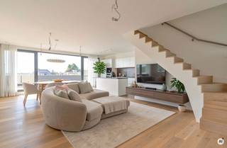 <p>Op zoek naar een zéér ruim en energiezuinig appartement met ondergrondse parking en kelderberging in hartje Beveren?<br /><br />Op de Grote Markt bevindt zich dit ruime duplexappartement uit 2020, met maar liefst 146,15 m² bewoonbare oppervlakte. Met drie slaapkamers, twee badkamers, twee terrassen van samen 19,97 m² en EPC-label A combineert het appartement een royale indeling met hedendaags wooncomfort en een centrale ligging.<br /><br />Het appartement strekt zich uit over de vierde en vijfde verdieping. Op de vierde verdieping komt u binnen via de ruime inkomhal, die toegang geeft tot de verschillende vertrekken. De royale leefruimte met open keuken vormt met haar oppervlakte van ruim 50 m² het hart van het appartement en biedt volop ruimte voor een comfortabele woon- en eetkamer.<br />De open keuken is praktisch en verzorgd ingericht en beschikt over een ziteiland met composieten werkblad, veel kastruimte en kwalitatieve toestellen van Miele. <br />Vanuit de leefruimte heeft u rechtstreeks toegang tot het zonnige terras van 13,35 m², een aangename uitbreiding van de woonruimte.<br /><br />Deze verdieping beschikt tevens over een eerste slaapkamer met ensuite badkamer en toegang tot het tweede terras. Daarnaast zijn er nog een praktische wasberging en een apart gastentoilet voorzien.<br /><br />Via de stijlvolle vaste trap bereikt u de vijfde verdieping. Hier bevinden zich een bureau, dat eveneens als tweede slaapkamer kan worden ingericht, en een derde slaapkamer. Deze laatste geeft toegang tot een zolder/dressing en biedt zo bijkomende praktische ruimte. De tweede badkamer is uitgerust met een douche, lavabo en toilet. Dankzij deze indeling beschikt het appartement over drie volwaardige slaap- of werkruimtes en twee badkamers, verdeeld over beide verdiepingen.<br /><br />Op technisch vlak is het appartement uitstekend uitgerust. Het is voorzien van aluminium ramen met superisolerende dubbele beglazing, centrale verwarming op aardgas, ventilatie type D, een conforme elektrische installatie en een videofoniesysteem. Het gebouw beschikt bovendien over een lift. Met EPC-label A is het appartement daarenboven bijzonder energiezuinig.<br /><br />Een eigen ondergrondse parkeerplaats en een afzonderlijke kelderberging van ca. 3 m² zijn inbegrepen.<br /><br />Kortom, een bijzonder ruim duplexappartement op de Grote Markt in Beveren, met 146,15 m² bewoonbare oppervlakte, drie slaapkamers, twee badkamers, twee terrassen, een energiezuinig EPC-label A en een eigen ondergrondse parkeerplaats met kelderberging.<br /><br />Benieuwd? Contacteer ons voor bijkomende informatie en/of een bezoek via verkoop@homevast.be of tel. 03 344 77 44 en kom dit appartement persoonlijk ontdekken.</p>