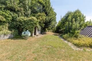 <h1><span>Charmingly situated renovation property on a 781 m² lot in the Flemish Ardennes</span></h1><p><span>In a beautiful location, on the slopes of the Wolvenberg, stands this characterful home on a 781 m² lot. A unique opportunity for anyone looking for a renovation project in a quiet, green setting.</span></p><p><span>The home features an entryway, a spacious and bright living area with an adjoining kitchen and dining area, two full-sized bedrooms, and a bathroom. A fixed staircase leads to the spacious attic, which offers numerous possibilities for creating additional bedrooms, a hobby room, or a home office.</span></p><p><span>In addition, the house has a full basement and a garage, providing extra storage space and practical convenience.</span></p><p><span>The garden, with its outbuildings, partially borders a nature reserve and offers a beautiful view of the surrounding countryside of the Flemish Ardennes. Here, you can enjoy peace, privacy, and a unique living environment.</span></p><p><span>Additional highlights:</span></p><ul><li><span>781 m² lot</span></li><li><span>Quiet, green location on the Wolvenberg</span></li><li><span>Full basement</span></li><li><span>Garage included</span></li><li><span>Fixed staircase to a spacious attic with potential for expansion</span></li><li><span>Oil-fired central heating (boiler installed in 2014)</span></li><li><span>Additional gas heater</span></li><li><span>Partially located in a nature reserve</span></li></ul><p><span>Are you looking for a home in an exceptional location that you can renovate entirely to your own taste? Then this property is definitely worth a visit.</span></p><p><span> </span></p><p><span>Schedule your appointment at jurgen@immodhondt.be</span></p>
