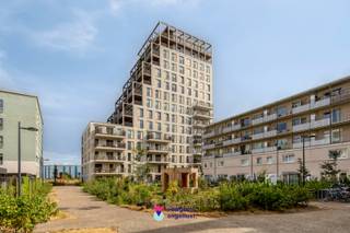 Op de 7de verdieping van residentie Pergola, in het hippe en bruisende De Nieuwe Dokken, bevindt zich dit uitzonderlijk luxueus afgewerkte appartement van maar liefst 121 m². Een stijlvolle woonbeleving waar ruimte, comfort en een fenomenaal uitzicht over het water en de stad Gent perfect samenkomen.<br />De ruime leefruimte baadt in het licht en sluit naadloos aan op het inpandige terras, vanwaar u elke dag geniet van een uniek zicht richting de Gentse binnenstad. De open keuken is volledig ingericht en afgewerkt met hoogwaardige materialen, perfect voor wie houdt van koken én gezellig tafelen.<br />Het appartement beschikt over twee ruime slaapkamers en een luxueuze badkamer met zowel een ligbad als een royale inloopdouche. In elke kamer, inclusief de badkamer, zijn stijlvolle ingemaakte kasten voorzien, waardoor comfort en opbergruimte hand in hand gaan.<br />De warme parketvloeren, gezellige inkomhal met zitbank en ingemaakte kasten en de ruime berging met extra maatkasten en wastafel onderstrepen de aandacht voor detail en wooncomfort.<br />Hier woont u in een rustige, moderne omgeving aan het water, maar tegelijk op wandelafstand van het historische centrum van Gent. Ook het station en de belangrijkste invalswegen zijn vlot bereikbaar.<br />Een bijzonder appartement voor wie verfijnd en comfortabel wil wonen op een toplocatie in Gent.<br /><br />Syndicuskosten: 150€/mnd<br />Bezoekdag: Woensdag 19 augustus