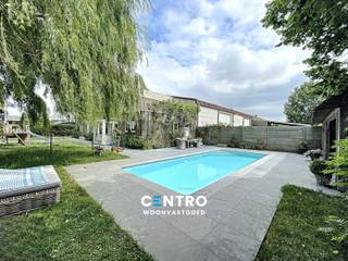 Ruime woning + magazijn (270m2) op KMO-grond te Knokke-Heist!<br /><br /><strong>INDELING:<br /><u>WONING:</u><br /><u><em>Gelijkvloers:</em></u></strong><br />Ruime inkomhal - afzonderlijk gastentoilet - LICHTRIJKE woonkamer - volledig ingerichte keuken (O.a. met keramisch fornuis, dampkap, heteluchtoven, microgolfoven en vaatwasmachine) - 2 bureelruimtes - berging -  volledig aangelegde en omheinde tuin met ruim zonneterras, verwarmd zwembad (30m2) én poolhouse (29m2).<br /><br /><u><em><strong>Eerste verdieping:</strong></em></u><br />Nachthal - badkamer (O.a. met dubbel lavabomeubel, ligbad en douche) - 3 volwaardige slaapkamers - wasplaats - 2 ruime dakterrassen.<br /><br /><u><strong>MAGAZIJN:</strong></u><br />- Brede inrit, afsluitbaar via elektrische poort.<br />- Parkeergelegenheid + extra buitenopslag.<br />- Circa 270 m2.<br />- Eventuele uitbreidingmogelijkheid.<br />- Magazijn momenteel verhuurd (Beschikbaarheid bespreekbaar).<br /><br /><u><strong>Opmerkingen;</strong></u><br />- Grondopp.: 1.401m2.<br />- Bewoonbare opp.: 240m2<br />- Straatbreedte: Circa 43m.<br />- Kwalitatief afgewerkte poolhouse (Massieve eik en rieten dak).<br />- CV op aardgas.<br /><br />Aarzel zeker niet om ons te contacteren voor verdere info en/of een bezoek ter plaatse: 050/70.01.02 - info@centro.be.