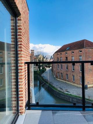 Dakappartement met mezzanine in gerenoveerde stadswoning van +/- 120m2 met 1 slaapkamer en 2 terrassen te huur in het historisch centrum van Diest, Demerstraat 13.<br /><br />Het appartement is gelegen op de tweede verdieping in een karaktervolle woning bestaande uit 3 appartementen.<br />Het is gelegen op een werkelijk unieke locatie : in het pittoreske kader van de stad Diest, vlak aan het water met zicht op 't Spijker, op een steenworp van de Grote Markt en 5 wandelminuutjes van het station.<br /><br />Via de charmante gezamenlijke inkomhal en ruime trappenhal komt u in het appartement. De ruime leefruimte met veel lichtinval beschikt over een mezzanine en open keuken. Vanuit de leefruimte hebt u toegang tot de twee terrassen met zicht op de Demer. De moderne keuken is voorzien van alle comfort en een aparte ruime berging. Het keukeneiland geeft plaats aan een ontbijthoek. De smaakvol ingerichte badkamer beschikt over een inloopdouche, moderne wastafel met spiegel en toilet. Dit alles ademt de sfeer uit van een gezellige ruime loft.<br /><br />Indeling :<br />- inkomhal<br />- leefruimte met open keuken (40m2)<br />- mezzanine/slaapkamer (20m2)<br />- badkamer<br />- toilet<br />- 2 berging/dressing<br />- 2 terrassen<br /><br />Voorzieningen :<br />- vloerverwarming<br />- raamdecoratie<br />- lichtarmatuur<br />- geschilderd, instapklaar<br />- terrasmeubilair<br />- luxueuze afwerking<br />- gezamenlijke berging voor fietsen<br />- epc : 134 kWh/m2<br /> <br />Huurprijs : € 875,00 + € 45,00 vaste gemeenschappelijke kosten per maand<br /><br />Wij maken graag tijd voor u om dit prachtig appartement met zijn unieke locatie te bezoeken.<br />Voor afspraak : 013/311.233