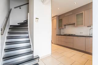 Deze charmante rijwoning is gelegen in het aangename Lembeek en bevindt zich nabij winkels, scholen, openbaar vervoer en belangrijke invalswegen. De woning werd op de verdiepingen reeds gerenoveerd, terwijl het gelijkvloers nog lichtjes verder afgewerkt dient te worden.
We betreden de woning via de inkomhal en komen terecht in de keuken. Deze geeft uit op de eet- en leefruimte, die op haar beurt toegang biedt tot de gezellige koer. Op het gelijkvloers bevindt zich tevens een apart toilet.
Met de trap begeven we ons naar de eerste verdieping waar we twee slaapkamers aantreffen. Verder beschikt deze verdieping over een badkamer uitgerust met een bad met douche, lavabo en toilet.
De zolderverdieping werd ingericht als slaapkamer en biedt hierdoor een derde volwaardige slaapruimte.
Tot slot beschikt de woning over een praktische kelder, ideaal als extra opbergruimte.
Deze woning biedt dankzij de reeds gerenoveerde verdiepingen en de verdere afwerkingsmogelijkheden op het gelijkvloers een interessante opportuniteit voor starters, gezinnen of investeerders.