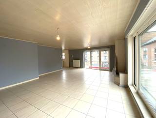 Ruimte, licht en een uitstekende ligging: dit ruime appartement van maar liefst 147 m² heeft het allemaal!<br /><br />Op wandelafstand van alle dagelijkse voorzieningen — waaronder de bakker, winkels, openbaar vervoer, scholen en belangrijke invalswegen — bevindt zich dit lichtrijke en instapklare appartement, voorzien van alle hedendaagse comfort.<br /><br />De centrale ligging, de royale leefruimtes en het grote zonnige terras met open zicht vormen slechts enkele van de vele troeven van deze eigendom.<br /><br />Indeling is als volgt:<br /><br />- Centrale inkomhal met toegang tot de verschillende leefruimtes.<br />- Ruime en lichtrijke leefruimte met een sfeervolle inbouwcassette op aardgas, geïntegreerd in een stijlvolle natuurstenen wand<br />- Zeer ruime, aparte leefkeuken met mooie schuifdeur, uitgerust met dubbele spoelbak, vaatwasser, keramische kookplaat, dampkap en oven<br />- Praktische berging/wasplaats<br />- 2 volwaardige slaapkamers, waarvan één aan de voorzijde en één aan de achterzijde, rustig gelegen<br />- Ingerichte badkamer met toilet, ligbad en dubbele lavabo met meubel<br /><br />Achteraan bevindt zich een groot en zonnig terras waar je heerlijk kunt genieten van de rust en het open uitzicht.<br /><br />Extra troeven: <br /><br />- Centrale verwarming op aardgas<br />- Stadswater<br />- PVC-ramen met dubbele beglazing<br />- Kwalitatieve materialen<br />- Stijlvolle massieve binnendeuren<br />- Energiezuinig: EPC-label B – 161 kWh/m²/jaar<br />- Elektrische installatie conform<br />- Lift aanwezig<br /><br />Ben je op zoek naar een ruim en lichtrijk appartement met een groot zonnig terras, gelegen in de dorpskern en op wandelafstand van alle voorzieningen? Dan is dit appartement absoluut een bezoek waard!<br /><br />Syndic kosten: 50 € / maand<br />Onmiddellijk beschikbaar.