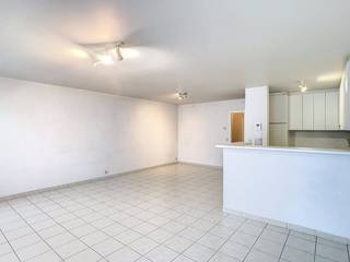 This apartment is located in the heart of Poperinge, in the Doornstraat, within walking distance of the Grote Markt and across the street from WZC Huize Proventier. It is located on the first floor and is accessible by elevator. The apartment has been repainted.Layout: * Floor +1: - entrance hall with cloakroom closet - separate toilet - bright living room with open kitchen with oven, fridge, double sink and ceramic hob with hood- storage - laundry room - bathroom with bath with shower facilities, sink and built-in cupboards- 2 bedrooms (12 &amp; 11 m²)- east-facing terrace* Ground floor 0: - communal bicycle and waste storage=> EPC label B=> Immediately available=> Mostly repainted=> Syndic fees included