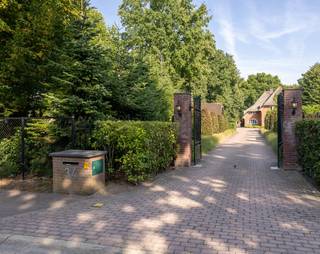 Deze karakteristieke en indrukwekkende villa op een perceel van 55a62ca (5.562 m²) wordt verkocht!<br /><br />De villa bevindt zich op een fijne locatie in Hamont-Achel, op loopafstand van het centrum en recht tegenover het gezellige stadspark met speeltuin en tennispark.<br /><br />Zodra we de oprijlaan zien, merken we direct dat dit pand een uniek pareltje is. Via een automatische poort rijden we het perceel op, voorzien van prachtige groenaanplanting, tuinverlichting en volledige privacy. Aan de voorzijde bevindt zich een ruime overkapping met laadpaal voor elektrische auto’s, momenteel ingericht als outdoor/overkapte gym, en met voldoende plaats voor het parkeren van meerdere auto’s. De villa is volledig omgeven door groen (eigen bos/bomen) en heeft een prachtig rieten dak. Rondom de volledige achtertuin bevindt zich een bos, met looppad en veel mogelijkheden om te spelen voor kinderen.<br /><br /><br />Buiten ademt de fraai aangelegde, onderhoudsarme tuin een gevoel van rust en luxe. Vanuit de leefruimte stapt u het terras op, waar het buitenleven zich in volle glorie ontvouwt. Het verwarmde zwembad kreeg vorig jaar een volledige renovatie: de installatie werd vernieuwd naar een zout- en magnesiumsysteem en het terras rondom is helemaal vernieuwd.<br /><br /><br />Naast het zwembad bevindt zich een barrelsauna die zowel Fins als infrarood kan worden gebruikt, ideaal om het buitenleven in alle seizoenen te beleven. Verspreid door de tuin liggen intieme zithoekjes, telkens met hun eigen sfeer. Voor kinderen en sportievelingen zijn er bovendien twee extra troeven: een ingebouwde trampoline en een professioneel aangelegd sport- en basketbalveld.<br /><br /><br />De villa (417m², volledig asbestvrij, elektriciteit conform 2025, EPC-label B met score 191) werd recent in 2024 volledig gerenoveerd, met focus op het behoud van de karakteristieke sfeer. Overal zijn radiatoren voorzien, er hangen 7 airco’s (voorzien om zowel te koelen als te verwarmen) en er zijn 16 zonnepanelen geplaatst op het bijgebouw.<br /><br /><br />Vanuit de royale inkomhal is er toegang tot het aparte toilet, een slaapkamer/bureauruimte, het verdiep en de leefruimte met open keuken. Deze leefruimte heeft een fantastisch zicht op de tuin, sluit naadloos aan op de eetkamer en is met behoud van karakter zeer elegant gerenoveerd. De keuken beschikt over een natuurstenen blad met kookeiland, is uitgerust met een Bora kookplaat, Quooker, alle nodige toestellen en extra’s, en valt op door de grote hoeveelheid lichtinval. In de leefruimte vinden we een mooie gashaard, ramen met glas-in-looddetails en een massief houten visgraatparket (gelegd in 2024).<br /><br /><br />Verder is er nog een tuinkamer (momenteel ingericht als home cinema, maar ook bruikbaar als bureau of slaapkamer) met prachtig zicht naar de tuin. Op het gelijkvloers vinden we daarnaast een wasruimte, voorzien van een handige linnenkoker vanuit twee slaapkamers boven, een doucheruimte en een apart toilet.<br /><br /><br />Op de eerste verdieping bevinden zich drie zeer ruime slaapkamers. De kleinste is 21m² en de grootste 50m², inclusief eigen zithoek. Twee slaapkamers beschikken bovendien over een dakterras. Alle slaapkamers zijn voorzien van sfeervolle en functionele inbouwkasten, recent geplaatst tijdens de renovatie van 2024. Verder is er een badkamer met bad en douche, en een apart toilet.<br /><br /><br />De tweede verdieping is volledig ingericht als master suite met badkamer-en-suite (bad en douche), een grote inbouwdressing en de mogelijkheid om ook hier een home cinema te voorzien.<br /><br /><br />De eerste en tweede verdieping zijn net als het gelijkvloers afgewerkt met een volledig massief houten visgraatparket (2024). Ook de trappen zijn professioneel gerenoveerd met massief hout, zodat alles perfect aansluit bij de warme en stijlvolle sfeer van de woning.<br /><br /><br />Tot slot beschikt de villa over een ruime kelder met meer dan voldoende opbergmogelijkheden.<br /><br /><br />Kortom: deze villa combineert uitzonderlijk wooncomfort met volledige privacy, een onderhoudsarme tuin, een unieke buitenomgeving en luxueuze extra’s — én dat alles op een toplocatie in Hamont-Achel.<br /><br /><br />Wenst u deze villa te bezichtigen? Contacteer ons via 011 64 55 00 of info@vastgoedfransen.be.