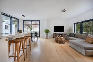 <p><span>In een groene en rustige omgeving in Tremelo bevindt zich deze prachtige open bebouwing, die in 2023 volledig en met bijzondere aandacht voor materiaalkeuze en afwerking werd gerenoveerd. De woning combineert een hedendaagse uitstraling met warme materialen, een doordachte indeling en een aangename connectie met de omliggende tuin. Ondanks haar groene ligging bevinden tal van winkels, supermarkten en dagelijkse voorzieningen zich op wandelafstand. Een bijkomende troef is dat alle woonruimtes zich op het gelijkvloers bevinden, wat zorgt voor bijzonder comfortabel wonen.</span></p>
<p><span>Via de inkomhal op parketvloer, waar nog een vestiairekast op maat zal worden voorzien, betreden we de woning. Een elegante smeedijzeren deur geeft toegang tot de bijzonder lichtrijke woon- en leefruimte, waar keuken, eetkamer en salon naadloos in elkaar overvloeien. De doorlopende parketvloer en grote raampartijen zorgen voor een warm en open ruimtegevoel. In de woonkamer werd bovendien een aansluiting voor een gashaard voorzien, ideaal voor wie extra gezelligheid wenst te creëren.</span></p>
<p><span>De volledig ingerichte keuken vormt een echte blikvanger en is voorzien van een centraal kookeiland met een Novy-inductiekookplaat met geïntegreerde dampkap. Daarnaast beschikt de keuken over een combi-microgolfoven, ruime koelkast en volledig geïntegreerde vaatwasser. Het geheel werd stijlvol afgewerkt met een Corian-werkblad.</span></p>
<p><span>Via de grote schuiframen in de eetkamer bereiken we het recent aangelegde, overdekte terras. Dankzij de geïntegreerde lichtkoepels blijft ook hier de natuurlijke lichtinval behouden. De ruime oppervlakte biedt voldoende plaats voor een volwaardige buiteneetkamer, ideaal om in alle comfort van de groene omgeving te genieten.</span></p>
<p><span>Terug via de hal bereiken we de twee volwaardige slaapkamers, eveneens afgewerkt met parketvloer. De eerste slaapkamer bevindt zich aan de voorzijde van de woning en kan perfect dienstdoen als kinder-, logeer- of bureauruimte. Aansluitend bevindt zich een afzonderlijke badkamer, volledig afgewerkt in Mortex en uitgerust met een inloopdouche, hangtoilet en enkele wastafel met meubel.</span></p>
<p><span>Achteraan bevindt zich de ruime master bedroom, met een aangenaam uitzicht op de tuin. Deze beschikt over een open dressing en een prachtige ensuite badkamer, eveneens volledig afgewerkt in Mortex. Hier vinden we een stijlvol ligbad, dubbele wastafel met meubel en toilet.</span></p>
<p><span>Aansluitend bevindt zich een praktische berging met aansluitingen voor wasmachine en droogkast, waar ook de technische installaties discreet werden geïntegreerd. Vanuit deze ruimte is er bovendien een rechtstreekse toegang tot het terras.</span></p>
<p><span>De woning wordt volledig omringd door een recent aangelegde tuin, die samen met het nieuwe terras een bijzonder aangename en groene buitenomgeving creëert. Daarnaast beschikt het eigendom over een afzonderlijk bijgebouw, momenteel ingericht als garage en opslagruimte. Dit biedt bijkomende mogelijkheden voor wie nood heeft aan extra werk- of hobbyruimte, eventueel voor de uitoefening van een vrij beroep, mits de nodige toelatingen.</span></p>
<p><span>Met haar kwalitatieve renovatie uit 2023, verfijnde materiaalkeuze en harmonieuze verbinding tussen binnen- en buitenruimtes biedt deze instapklare woning een bijzonder aangename woonomgeving, waar rust, groen en gelijkvloers wooncomfort centraal staan. (De laatste details worden afgewerkt vóór verkoop).</span></p>