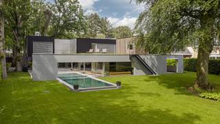 <p><strong>Deze architectenwoning is onder architectuur van architect Stéphane Beel gebouwd en in 2024-2025 volledig verbouwd alsook energetisch gebracht tot een A-label villa. De villa ligt in een fraaie parktuin van ca. 3.289 m² en geniet van prachtig lichtinval.</strong><br /><br /><strong>De gelijkvloerse verdieping:</strong><br />- <strong>I</strong><strong>nkomhal </strong>op natuursteen met maatwerk ingemaakte kasten en gastentoilet met natuurstenen handenwasser<br />- Zeer <strong>lichtrijke leefruimte </strong>op parket met <strong>gashaard</strong>, zithoek en brede schuiframen naar terras en zwembad<br />- <strong>E</strong><strong>etkamer</strong>, afsluitbaar met stalen deur, aansluitend op de leefkeuken, eveneens met directe toegang tot terras en <strong>zwembad</strong><br />- <strong>D</strong><strong>esignkeuken</strong> met centraal Fior Di Bosco marmeren<strong> eiland</strong> en<strong> ingebouwde apparatuur</strong>: <strong>SMEG </strong>7-pits gasfornuis, <strong>Venduro </strong>dampkap, <strong>4 elektrische ovens</strong>, dubbele gootsteen, <strong>dubbele Whirlpool (</strong>ijskast &amp; diepvriezer), 2 <strong>Miele</strong> vaatwassers en een <strong>wijnklimaatkast </strong>van AVintage<br />- Aansluitende <strong>wasplaats </strong>met toegang tot kelder (technische ruimte, opslag, kruipkelder)<br />- <strong>O</strong><strong>verdekt terras</strong> met ingewerkte elektrische <strong>screens</strong>, ideaal om het hele jaar door te genieten<br />- <strong>S</strong><strong>tudio</strong>/slaapkamer op parket, met maatwerkkasten en aansluitende <strong>douchekamer </strong>(inloopdouche, lavabo en toilet). Ideaal als logeerkamer of praktijkruimte<br />- <strong>H</strong><strong>obbykamer </strong>op parket, met ingemaakte kasten, schuifraam naar terras en stalen deur naar bureau<br />- <strong>B</strong><strong>ibliotheek/bureau</strong> op parket, ingewerkte kasten en schuifraam naar terras<br />- Technische berging <br />- <strong>Garage</strong> met sectionaalpoort, plaats voor 2 wagens en doorkijkraam naar de tuin <br /><br /><strong>De eerste verdieping:</strong><br />- <strong>Hoofdslaapkamer</strong> op parket, maatwerkkasten, <strong>dressing </strong>en ensuite <strong>badkamer </strong>met inloopdouche, dubbele lavabo, ligbad, toilet en toegang tot het <strong>dakterras</strong><br />- 3 volwaardige <strong>slaapkamers</strong>, allen op parket, met ingemaakte kasten en schuifraam naar terras, waarvan één slaapkamer voorzien van lavabo en douche<br />- <strong>Douchekamer </strong>met inloopdouche, lavabo en toilet<br />- Nachttoilet in de nachthal<br /><br /><strong>De tuin:</strong><br />- <strong>Verwarmd overloopzwembad</strong> (4m op 14 m en 60 à 1.80m diep), warmtepomp via zonnepanelen/elektriciteit, automatische filtering<br />- <strong>Overdekt terras </strong>met <strong>haard </strong>en geïntegreerde muziekboxen, omgeven door weelderig groen en volwassen oude bomen<br />- Volledig omheinde tuin prachtige z<strong>uid</strong> georiënteerde parktuin (tuinarchitect uit Parijs) vooraan met <strong>automatische poort</strong>, <strong>3-5 parkeerplaatsen</strong><br />- <strong>Zonneterras </strong>met groendaken en daarop een <strong>bijgebouw </strong>met <strong> wellness: sauna, zonnebank, hamam &amp; fitness</strong><br /><strong><br />Algemeen:</strong><br />- <strong>Totaalrenovatie </strong>in <strong>2024/2025 </strong>: dak, gevel, sanitair, keuken, vloeren, badkamers, zwembad, tuin en technische installaties,...<br /><strong>- Energiezuinige woning (EPC A – BEN-normering) </strong><br /><strong>- 24 zonnepanelen (405Wp/paneel) en</strong> <strong>4 thuisbatterijen, Hybride WP voor de villa en aparte WP voor het zwembad.</strong><br /><strong></strong></p>