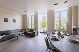 Karaktervol appartement met ruim terras op toplocatie<br /><br />Op een uitzonderlijke locatie aan de Groenplaats, met uitzicht op het Hilton Hotel en op wandelafstand van de Grote Markt, de Meir en de Wilde Zee, bevindt zich dit charmante appartement in een kleinschalige residentie.<br /><br />Via de stijlvolle inkomhal bereikt u het appartement op de eerste verdieping. De ruime en lichtrijke leefruimte met parketvloer biedt een prachtig uitzicht op de Groenplaats. Aansluitend bevindt zich de luxueus uitgeruste open keuken, voorzien van alle hedendaagse comfort, een kookeiland en een gezellige ontbijthoek.<br /><br />Vanuit de keuken leidt een korte trap naar het lager gelegen deel. Hier bevindt zich een praktische bureauruimte in de gang, met toegang tot het rustig gelegen terras. Op dit niveau vindt u tevens een ruime slaapkamer met een ensuite badkamer, uitgerust met een lavabo, douche en toilet en een wasplaats.<br /><br />Via een kleine trap bereikt u het hoger gelegen deel, waar zich een tweede ruime slaapkamer bevindt met een ensuite dressing. Daarnaast is er een volledig uitgeruste, royale badkamer.<br /><br />Een absolute troef van dit appartement is het gezellige en rustig gelegen terras, waar u in alle privacy kunt genieten van een oase van rust, midden in het bruisende stadscentrum.<br /><br />Daarnaast is er de mogelijkheid om een staanplaats aan te kopen in de naastgelegen residentie voor € 35.000.