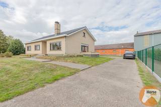 LOKEREN - Landelijk gelegen bedrijfswoning met stallencomplex<br /><br />Deze gunstig gelegen hoeve in bungalowstijl, te renoveren naar eigen smaak, bevindt zich op een perceel van 3.942 m². De eigendom geniet een rustige, landelijke ligging, maar ligt tegelijk dicht bij belangrijke verbindingswegen zoals de E17 en R4. Beervelde-dorp bevindt zich op korte afstand, terwijl Lokeren en Lochristi slechts ongeveer 10 minuten rijden zijn.<br /><br />De woning is opgetrokken in bungalowstijl en beschikt over een praktische indeling. Je komt binnen in een lichtrijke, ruime centrale inkomhal die toegang biedt tot de woonkamer, keuken, drie slaapkamers, toilet en badkamer. Daarnaast is er een aanpalende garage en een zolderruimte, die ideaal dienst kan doen als extra berging.<br /><br />De woning wordt verwarmd op stookolie. Bovendien beschikt het pand over een kruipruimte en een aparte oprit die rechtstreeks toegang biedt tot het stallencomplex.<br /><br />De eigendom is gelegen in agrarisch gebied, waardoor ze uitsluitend bestemd is voor landbouwactiviteiten. Een louter woongebruik zonder landbouwfunctie is in deze zone momenteel niet toegestaan. De mogelijkheid om de site om te vormen tot een particuliere eengezinswoning met loods wordt momenteel onderzocht bij de stad Lokeren.<br /><br />Achteraan het perceel bevindt zich een ruim stallencomplex, bestaande uit acht compartimenten van telkens circa 50 m² en een grote centrale stal van ongeveer 375 m². De totale afmetingen van de stal bedragen ongeveer 55 meter lang en 15,5 meter breed.<br /><br />Interesse om de woning te bezoeken? Neem contact op via 053/60.65.66 voor een afspraak.