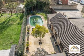 Deze ruime halfopen bebouwing ontvangt je in een grote inkomhal met gastentoilet en vestiaire. Zo treedt je binnen in een riante L-vormige leefruimte, bestaande uit een gezellige zithoek met haard en een grote eethoek. Aanpalend vinden we een heel ruime leefkeuken, waar er naast veel werk- en opbergruimte ook voorzien is een leuk eiland en een klassevol kookvuur. Het uitzicht naar de buitenzone vormt hier nog een bonus : een grote afsluitbare lounge loopt naadloos over in een heel leuke tuin, zodat je het jaar rond van het buitenleven kan genieten. Vooraan de woning vinden we ook een eerste slaapkamer terug, met aanpalend de badkamer met ligbad en douche. Rond de overloop op de eerste verdieping vinden we drie grote slaapkamers en een apart toilet. Opbergruimte is er in overvloed in een aantal aparte ruimtes, en uiteraard biedt de grote garage naast plaats voor een wagen nog extra ruimte. De laatste troef van deze woning vinden we terug in de tuin : een stijlvol ingewerkt zwembad zorgt ervoor dat zelfs de warmste dagen van het jaar aangenaam verlopen. Bezoekdag: 11/04. Inschrijven via mail naar stefan@immo-home.be, geen telefonische inschrijvingen! Volg ons op Fb en Insta. Voor meer info: www.immo-home.be. GRATIS SCHATTING &amp; GRATIS FINANCIEEL ADVIES