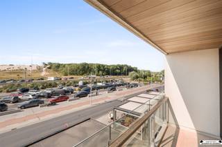 <p>Located on Kapelstraat, in the center of Bredene, is this beautifully maintained two-bedroom apartment. Thanks to its unique location with an unobstructed view of the dunes and shops just 20 meters away, this is an excellent choice as an investment, second home, or primary residence.</p><p>The apartment is currently rented out and offers a gross return of nearly 3.5%. It is possible to take over the lease from the current tenant. In addition, the lease for a locked garage (approx. €100/month) can also be taken over.</p><p>Take the elevator to the second floor. You’ll enter the bright living area with an open, fully equipped kitchen. The large windows and the wide sliding door leading to the front terrace provide an abundance of natural light and a beautiful, unobstructed view of the Bredene dunes.</p><p>Through the night hall, you’ll find a separate toilet, a practical storage room with connections for a washing machine and dryer, and the bathroom, equipped with a sink, bathtub, and shower.</p><p>At the rear of the apartment are two spacious bedrooms, one of which opens onto a sunny, south-facing terrace.</p><p><strong>Key features:</strong></p><ul><li>Unique view of the dunes, right in the heart of the city center</li><li>Ideal as an investment, second home, or primary residence</li><li>Two spacious bedrooms and two terraces </li><li>Option to rent a garage</li></ul><p><br />In short, a move-in-ready apartment in a prime location offering a great return on investment and all amenities within easy reach. Feel free to contact us for more information or to schedule a visit.</p>