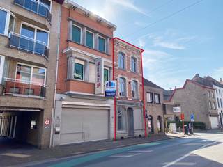Bent u op zoek naar een woning met een uniek verhaal en eindeloze mogelijkheden? Dit solide pand uit 1957, gelegen in de levendige Bruggestraat, ademt karakter en biedt een zee aan ruimte. Waar vroeger de geur van verse broodjes de buurt verblijdde in de voormalige gelijkvloerse broodjeszaak, wacht nu een nieuwe toekomst.  Dit gebouw uit de late jaren 1950 combineert de stevige bouwkwaliteit van die tijd met een veelzijdige indeling. Het voormalige handelspunt op het gelijkvloers biedt een fantastische basis voor wie droomt van een ruim thuiskantoor, een atelier of simpelweg een riante extra leefruimte. De grote raampartijen aan de straatzijde zorgen voor een veellichtinval en een directe connectie met de omgeving.  Boven de voormalige handelsruimte bevindt zich het woongedeelte, waar de authentieke sfeer van de jaren '50 nog voelbaar is. Met zijn ruime vertrekken en logische opbouw is dit de ideale basis voor een renovatieproject dat modern comfort combineert met retro-charme.