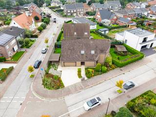 In een rustige woonwijk, op wandelafstand van het station, vinden we op een mooi hoekperceel deze uitzonderlijk ruime gezinswoning met maar liefst 7 slaapkamers.<br /><br />De villa werd opgetrokken in de jaren tachtig, met één duidelijke focus: ruimte voor het hele gezin. Dat vertaalt zich vandaag in royale leefruimtes, een bijzonder praktische indeling en heel wat mogelijkheden om de woning naar eigen smaak te moderniseren.<br /><br />Via de ruime inkomhal met ingebouwde vestiairekast betreden we de woning. Rechts bevindt zich een afzonderlijke zitruimte, die aansluit op de ruime, tweedelige leefruimte. Verder vinden we een grote, aparte leefkeuken met aansluitend een bijzonder praktische en ruime koele berging.<br /><br />Naast de keuken bevinden zich de ingerichte wasberging en een eerste badkamer met douche. Van hieruit is er rechtstreeks toegang tot de dubbele garage, die zowel langs de voor- als achterzijde bereikbaar is.<br /><br />De verschillende leefruimtes op het gelijkvloers zijn vandaag afzonderlijk ingedeeld, maar bieden dankzij hun oppervlakte en indeling heel wat potentieel. Wie houdt van een hedendaags en open ruimtegevoel kan hier verschillende ruimtes samenbrengen tot één royale leefomgeving.<br /><br />Ook op de eerste verdieping blijft ruimte het sleutelwoord. Hier bevinden zich maar liefst 7 slaapkamers, een tweede badkamer, een afzonderlijk toilet en een extra berging. Een uitzonderlijke indeling die deze woning bijzonder geschikt maakt voor grote of nieuw samengestelde gezinnen, maar evengoed voor wie nood heeft aan extra bureel, hobby of logeerruimte.<br /><br />Buiten geniet u van een aangenaam aangelegde tuin met terras. Dankzij het hoekperceel is er bovendien een mooi gevoel van ruimte rondom de woning. Parkeren kan op eigen terrein en bijkomend in de straat.<br /><br />Bent u op zoek naar een bijzonder ruime gezinswoning met 7 slaapkamers, een dubbele garage en tal van mogelijkheden, en dit op een centrale maar rustige ligging? Dan verdient deze woning absoluut uw bezoek.<br /><br />Extra troeven:<br /><br />Maar liefst 7 slaapkamers<br /><br />Dubbele garage<br /><br />Ruime en veelzijdige leefruimtes<br /><br />Drijfkracht aanwezig<br /><br />Regenwaterput van 10.000 liter<br /><br />Aangename tuin en terras<br /><br />Parkeermogelijkheden op eigen terrein