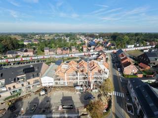 PIAZZA (Italiaans voor 'Plein') is de naam van het schitterende nieuwbouwproject dat zal gerealiseerd worden in het centrum van Tielen.<br />De oude en leegstaande feestzaal aan het dorpsplein zal plaats ruimen voor een stijlvol gebouw met 9 appartementen en een handelsruimte.<br /><br />Het project is een initiatief van de ontwikkelaars Frank Van Nijlen en Jan Daems die samen al enkele knappe woonprojecten afleverden in Lichtaart en Kasterlee. De architectuur is van de hand van Leen Van Lommel, eveneens uit Kasterlee.<br /><br />De ligging van dit project is ronduit subliem: de terrassen en leefruimtes kijken uit op het marktplein en het oude beschermde gemeentehuis, scholen en winkels (Spar, bakker, apotheek) liggen op wandelafstand. Maar de grote troef is de aanwezigheid van het openbaar vervoer! Het treinstation van Tielen biedt rechtstreekse verbindingen naar Antwerpen (ca. 30') en Brussel (ca. 60'). Ook de oprit naar de E34 Antwerpen-Eindhoven is maar 5' met de wagen.<br /><br />Het handelsgelijkvloers ligt aan de pleinzijde (268m²) en is uitermate geschikt voor een vrij beroep, dienstverlening of detailhandel (fietsen, boetiek, etc.). Deze ruimte wordt CASCO (Wind-en waterdicht) verkocht. Het gelijkvloerse appartement is reeds verkocht.<br /><br />Er zijn 3 klassieke appartementen op de eerste verdieping. <br />Tenslotte zijn er 5 ruime duplex-appartementen waarvan er in voorverkoop reeds 2 werden verkocht.<br /><br />Bij het project hoort een grote ondergrondse parking met individuele parkeerplaatsen (22.000 €) en bergingen (5.000 €).<br /><br />Als energiebron werd door de ontwikkelaar gekozen voor geothermie. Alle appartementen hebben vloerverwarming en het E-peil zal schommelen rond 10.<br />De kopers hebben inspraak in de afwerking van hun appartement (keuken, badkamer, vloeren, etc.). Alles gebeurt in nauw overleg met de klantenbegeleider van de bouwheer.<br /><br />De werken zullen starten in het voorjaar van 2025 en zullen anderhalf jaar in beslag nemen.
