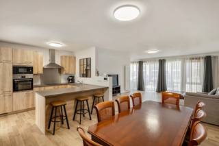 Ruim en volledig gerenoveerd gelijkvloers appartement met tuin<br />Dit ruime gelijkvloerse appartement van ca. 125 m² werd in 2024 grondig gerenoveerd en combineert een aangenaam ruimtegevoel met hedendaags wooncomfort. Dankzij de grote raampartijen en de open indeling geniet het appartement bovendien van veel natuurlijke lichtinval.<br />Bij het betreden van het appartement valt meteen de ruime leefruimte op. Deze biedt voldoende plaats voor zowel een comfortabele zithoek als een grote eettafel en sluit mooi aan op de open keuken. De keuken werd praktisch ingericht met veel kastruimte, een ruim werkblad, ontbijthoek en diverse ingebouwde toestellen.<br />Via de lichtrijke doorgang bereik je het overige gedeelte van het appartement. Hier bevinden zich onder meer een ruime slaapkamer, een bijkomende kamer die perfect kan worden ingericht als tweede slaapkamer, bureau of hobbyruimte, en de vernieuwde badkamer. De badkamer is voorzien van een moderne inloopdouche, wastafelmeubel en toilet en biedt eveneens plaats voor wasmachine en droogkast.<br />Een belangrijke troef is de private tuin, waardoor je ook als bewoner van een appartement beschikt over een aangename eigen buitenruimte.<br />Het appartement werd in 2024 gerenoveerd en is bijgevolg instapklaar. Ook op technisch vlak scoort het uitstekend: het beschikt over een EPC-label B, de elektrische installatie is conform en het appartement is asbestvrij.<br /><br />Troeven:<br />✅ Gelijkvloers appartement<br />✅ Ca. 125 m² bewoonbare oppervlakte<br />✅ Gerenoveerd in 2024<br />✅ Vernieuwde badkamer met inloopdouche<br />✅ EPC-label B<br />✅ Elektrische keuring conform<br />✅ Asbestvrij<br />✅ Instapklaar<br /><br />Voor interactieve grondplannen met foto’s, ga naar www.wijns.be en klik op de knop “virtueel bezoek”.<br />Info & afspraak: ☎ 0473/33 33 10 ✉ geoffry@wijns.be
