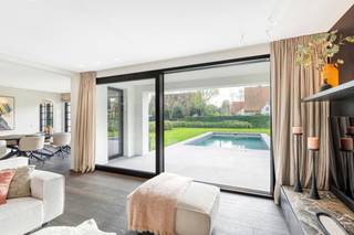 <strong>Zonnige, volledig vernieuwde villa met zwembad in het Zoute</strong><br /><br />Op een absolute toplocatie in het residentiële Zoute, rustig gelegen in een doodlopende straat nabij de Kalfsmolen, bevindt zich deze luxueuze alleenstaande villa met zwembad. De woning is omgeven door groen en ligt op slechts vijf minuten rijden van het centrum van Knokke. Via het nabijgelegen Koningsbos wandelt u in alle rust naar het strand en de Kustlaan.<br /><br />De villa werd volledig gestript en met hoogwaardige materialen vernieuwd. Ze biedt een uitzonderlijk wooncomfort met onder meer 6 slaapkamers, 5 badkamers en een zuidgerichte tuin met verwarmd zwembad. Dankzij de automatische toegangspoort bereikt u de ruime oprit met plaats voor vier wagens. Er is ook een inpandige garage.<br /><br />Indeling: inkomhal met vestiaire en gastentoilet, ruime leefruimte in parket met open haard en maatwerkkasten in fineer eik, aparte eetruimte met toegang tot het overdekte terras en de tuin. De moderne keuken is volledig uitgerust met Miele-toestellen en een marmeren werkblad. Praktische wasruimte met extra bergruimte.<br /><br />Op de eerste verdieping bevinden zich vier volwaardige slaapkamers, elk met ingebouwde kasten en een eigen badkamer of douchekamer. De tweede verdieping telt nog twee ruime slaapkamers, een douchekamer en een apart toilet op de nachthal.<br /><br />EPC: 198 kWh/m² (UC: 3014336-RES-1)