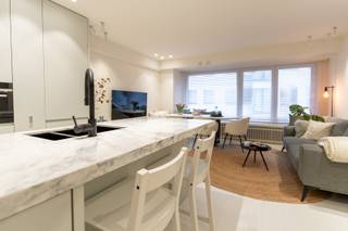 Ontdek dit prachtig gerenoveerde appartement gelegen op de 3de verdieping in de standingvolle residentie Drakkar. Het appartement geniet van een uitstekende ligging nabij de Kustlaan en het Driehoeksplein, en combineert hedendaags wooncomfort met een toplocatie aan zee. Het appartement bevindt zich in een centrale en commerciële omgeving met een vlotte bereikbaarheid van winkels, restaurants en diverse ontspanningsmogelijkheden.<br />Indeling van het appartement: inkomhal met vestiaire, eetkamer, volledig ingerichte keuken, aangename leefruimte met zijdelings zeezicht, drie slaapkamers, badkamer, afzonderlijk toilet en privatieve kelderberging. Achteraan is er een terras.<br />Het mooie meubilair is inbegrepen. 
