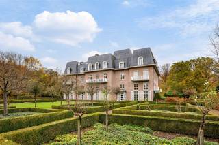 <p><span>Spacious castle apartment located in a unique location in the middle of the quiet park domain ‘Blauwhof’, near the center of Kapellen! The apartment includes an entrance hall, spacious living room with sunny terrace, dining room with enclosed terrace, separate kitchen, 2 bedrooms, 2 fitted bathrooms and 2 underground car parking spaces.</span></p><p><span> </span></p><p><span>LAYOUT</span></p><p><span> </span></p><p><span>Ground floor</span></p><p><span>The elevator takes you directly to the apartment. You enter a spacious entrance hall on epoxy floor, equipped with a guest toilet and checkroom. From the entrance hall you have access to the separate kitchen on epoxy floor, equipped with a stove hood, teppanyaki, built-in coffee machine, dishwasher, combi-oven/microwave, separate microwave, double fridge and sink.</span></p><p><span>Adjacent is a practical laundry room with ample storage cabinets and plumbing for a washer and dryer.</span></p><p><span>The dining room on parquet floor is accessible from the entrance hall and has an enclosed terrace and a useful storage cupboard.</span></p><p><span>A passage on parquet floor, with built-in closets, leads to the first bedroom on parquet floor, with built-in closets and a fully equipped bathroom on tiled floor, equipped with a bath, shower, double sink and toilet.</span></p><p><span>The second bedroom on parquet floor has an ensuite bathroom on tiled floor, equipped with a shower, single sink and toilet.</span></p><p><span> </span></p><p><span>Second floor </span></p><p><span>Through the wooden spiral staircase or by elevator you reach the second floor. Here there is a spacious and bright sitting area on parquet floor, with a cozy wood fireplace and a small kitchenette. From this room you have access to the sunny terrace with beautiful views of the greenery and the beautifully landscaped pond. </span></p><p><span> </span></p><p><span>Garage</span></p><p><span>The apartment has two underground car parking spaces: one enclosed garage box (mandatory to buy along for € 25,000) and one between lines (optional to buy along for € 25,000)</span></p><p><span> </span></p><p><span>Details</span></p><p><span>- Located in a coveted location: in a beautiful park domain ‘Blauwhof’ of 108.076 m², near the center of Kapellen and various amenities (restaurants, stores, schools, public transport,...). </span></p><p><span>- Living in a unique and classy castle.</span></p><p><span>- Elevator goes directly into the apartment (both ground and second floor).</span></p><p><span>- Spacious, sunny terrace with magnificent view of the greenery and the pond.</span></p><p><span>- The apartment has two underground parking spaces: one enclosed garage box (mandatory to buy along for € 25,000) and one between lines (optional to buy along for € 25,000).</span></p><p><span> </span></p><p><span> </span></p>