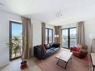 <strong>BRUSSEL: In het hart van de wijk Tour &amp; Taxis, dit opmerkelijke, lichte appartement van ±94 m², ongemeubileerd,  op de 11e verdieping met lift van een moderne residentie van hoge kwaliteit, gebouwd in 2022, combineert moderne architectuur, verfijnde afwerking en absolute veiligheid, een echt uitzonderlijk pand. Inkomhal met wc, elegante woonkamer van ± 25 m², terras van ±7 m² op het noorden met een volledig vrij uitzicht, volledig uitgeruste keuken (oven, magnetron, inductiekookplaat, afzuigkap, koelkast, diepvriezer en vaatwasser), een slaapkamer van ± 9 m² met aangrenzende doucheruimte, nachthall met dressing, badkamer met toilet, een slaapkamer van ± 14 m², wasruimte en een kelder. Diversen: driedubbele beglazing, glasvezel, waterontharder, fietsenstalling en een beveiligingssysteem. Mogelijkheid om een parkeerplaats te huren voor 130€/maand, niet verplicht. Kosten: voorzieningen van 180€/maand, inclusief gemeenschappelijke ruimtes, warm water en verwarming. EPC B+ Beschikbaar op 01/05/2026. Afmetingen zijn indicatief</strong><br /><br />
<p><u>Op de 11e verdieping met lift:</u> (11.2)</p>
<ul>
<li>Hal</li>
<li>Toilet</li>
<li>Woonkamer van ±25 m²</li>
<li>Ingerichte keuken (magnetron, inductiekookplaat, oven, afzuigkap, koelkast, diepvriezer en vaatwasser)</li>
<li>Slaapkamer van ±9 m² met doucheruimte</li>
<li>Nachtgang met dressing</li>
<li>Wasruimte</li>
<li>Badkamer met toilet</li>
<li>Slaapkamer van ±14 m²</li>
</ul>
<p>Kelder n°19</p>