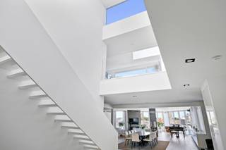 <div>
<div>
<div>
<p>This penthouse was renovated in 2017 by the Dutch interior architect Jan des Bouvrie. The apartment features a private elevator, a living area of 434 m², two large sun terraces totaling 130 m², three storage rooms, and one indoor parking space, with a second parking spot possibly available for purchase at €35,000. The entire apartment is secured with a keypad for triple security. There is colorful LED lighting, air conditioning, white high-gloss built-in cabinets, and Corian finishes. The open entrance hall on the sixth floor provides direct access to the large reception area, with a lounge and dining section, three designer gas fireplaces, and a fully equipped bar with Gaggenau appliances. These include a double fridge/freezer with ice maker, double wine fridge, professional coffee machine, combi-oven, dishwasher, and an instant hot water boiler. This floor also houses two bedrooms, each with a private bathroom equipped with a rain shower with mosaic tiles, double sink, and toilet. The master bedroom additionally features a double jacuzzi with built-in LED lighting. A floating staircase and an internal private elevator connect the sixth and seventh floors. On the seventh floor, there is a private lounge, dining area, library, kitchen with the same Gaggenau appliances as downstairs, and a third bedroom with a shower room. This floor has automatic sunshades and two sun terraces of 90 m² and 40 m². From here, you have a unique view of the Cathedral of Our Lady, the Boerentoren, and the city theater.</p>
</div>
</div>
</div>
<div>
<div></div>
</div>
<span><br /><br />Located in the heart of Antwerp city centre, this exclusive and luxurious duplex penthouse is a real feast for the eyes. Within walking distance of the famous Schuttershofstraat with its elegant shops and the Stadsschouwburg for optimal entertainment. Due to this ideal location, you can be in and out of the city in no time.<br /></span>