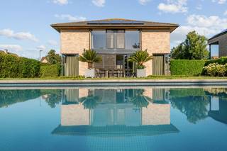 EXCLUSIEF AANBOD: Deze ruime en goed onderhouden villa vormt de perfecte basis voor een ontspannen leven aan de kust, omringd door comfort en luxe.<br /><br />De villa is gelegen in een rustige buurt en bevindt zich op een royaal perceel met privézwembad en inpandige garage. Op slechts 10min wandelen van zee en strand, ideaal voor natuurliefhebbers en zonaanbidders.<br /><br />Indeling: <br /><br />Riante inkomhall (open tot in het dak), afzonderlijk toilet met lavabo, berging/wasplaats met regenwaterpomp, ruime woonkamer 55m² (5x11m) met openhaard, open ingerichte leefkeuken (6x4m), grote dubbele garage (5,5x6m) met oprit voor twee wagens, open nachthall, 3 ruime slaapkamers waarvan één met grote dressing (mogelijkheid tot extra slaapkamer), badkamer met wastafel, ligbad, douche en twee toilet, grote bergkamer, grote geïsoleerde zolder, prachtig aangelegde zonnige tuin (zuid-gericht) met terras, groot verwarmd zwembad (3,5x11m), tuinhuis. <br /><br />- 16 Zonnepanelen<br />- Elektriciteit conform<br />- Geïsoleerd dak. <br />- Regenwaterput 15.000 liter