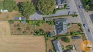 WETTEREN - Deze ruime en kwalitatieve villa, gebouwd met duurzame materialen, combineert een uitstekende bereikbaarheid met een rustige ligging en een blijvend vrij uitzicht over de omliggende weilanden. Gelegen langs de Oosterzelesteenweg, vlak bij de Gentse Steenweg en de oprit van de E40, vormt dit eigendom een ideale uitvalsbasis tussen Wetteren en Geraardsbergen.
Bij het binnenkomen valt meteen de royale inkomhal op, voorzien van vestiaire en gastentoilet. Van hieruit heeft u toegang tot een slaapkamer met badkamer, die ook perfect kan dienen als bureau of praktijkruimte. Aan de andere zijde bevindt zich de lichtrijke leefruimte van 50 m², waar u volop geniet van het zicht op de tuin en de open velden. De aangrenzende keuken, afgewerkt met hoogwaardige materialen, is praktisch ingericht en beschikt over een extra douche, een ruime berging en een wasplaats.
Op de verdieping treft u drie ruime slaapkamers, een bureau dat eenvoudig als extra slaapkamer kan worden ingericht, en een badkamer. Daarnaast is er nog een volwaardige studio die tal van mogelijkheden biedt, van bijkomende kamers tot hobbyruimte of afzonderlijke woonunit.
Ook op praktisch vlak heeft deze villa heel wat troeven. De woning is volledig onderkelderd (135 m²) met diverse stockageruimtes, ideaal voor wie een vrij beroep of commerciële activiteit wil uitoefenen. De inpandige garage van 75 m², met hoge inrijhoogte, is geschikt voor grote voertuigen zoals bestelwagens enz.. In de tuin is er nog een garage aanwezig.
Met een bewoonbare oppervlakte van ca. 280 m², kwalitatieve afwerking en een rustige maar goed bereikbare ligging biedt deze villa uitzonderlijk veel mogelijkheden. Of u nu een ruime gezinswoning zoekt, wonen en werken wil combineren of kangoeroe wonen overweegt: hier gaan stijl, comfort en functionaliteit harmonieus samen.
Aarzel niet en maak snel uw afspraak: 053/60.65.60.