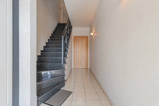 Bent u op zoek naar een ruim, instapklaar en energiezuinig appartement met veel natuurlijke lichtinval? Dan is dit appartement zeker een bezoek waard.<br /><br />Via de verzorgde inkomhal van het gebouw bereikt u met de trap het appartement op de eerste verdieping.<br /><br />De centrale inkomhal van het appartement biedt toegang tot de verschillende ruimtes. Vooraan bevindt zich de ruime en lichtrijke leefruimte met grote raampartijen, die zorgen voor een aangename lichtinval en een open gevoel. Aansluitend vindt u de open keuken, die mooi aansluit bij de leefruimte.<br /><br />Verder beschikt het appartement over een afzonderlijk toilet en een praktische berging met aansluitingen voor wasmachine en droogkast. Aan de achterzijde bevinden zich de badkamer en de slaapkamer. Vanuit de slaapkamer heeft u rechtstreeks toegang tot het ruime terras, een aangename buitenruimte om te ontspannen.<br /><br />Troeven van deze woning zijn de energiezuinigheid (EPC-label B), de lichtrijke leefruimtes, het ruime terras, de praktische indeling en de aanwezigheid van een garage.<br /><br />Huurprijs: € 875/maand<br />Gemeenschappelijke kosten: € 75/maand<br /><br />Foto’s 5, 8 en 10 zijn AI-bewerkte sfeerbeelden die tonen hoe de ruimtes eruit zouden kunnen zien met een mogelijke inrichting. Deze beelden zijn illustratief. <br /><br />Voldoet dit appartement aan uw wensen? Neem dan snel contact met ons op via info@pantheonvastgoed.be.