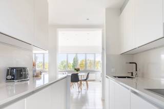 Renovated Three-Bedroom Apartment with Terrace and Panoramic Green ViewsEntrance hall with cloakroom and guest toilet with hand basin. Access to a...