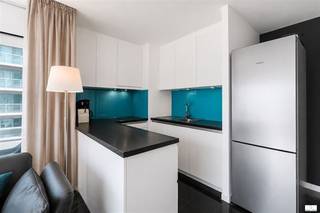 MODERN BEACHFRONT APARTMENT WITH OCEAN VIEW IN MIDDELKERKEThis stylishly furnished apartment is ideal for those who love comfort and a beachfront lifestyle in Middelkerke. With an open-concept kitchen and living area, an elegant sitting area, and direct ocean views, this home offers the perfect balance between compact living and luxury.INTERIOR HIGHLIGHTSThe living area combines a fully equipped kitchen with modern, high-quality finishes. The black-and-white design, accented with turquoise, lends a contemporary, sophisticated character. The kitchen features a built-in oven, a fridge-freezer, and practical countertops in a dark finish. The open layout makes the space feel larger and creates a cozy atmosphere that blends cooking and relaxation.The sitting area is comfortably furnished with stylish, substantial armchairs and a coffee table, perfect for relaxation. A bedroom equipped with built-in closets and LED lighting offers a soothing retreat. A modern bathroom with a shower, sink, and mirror completes the space with a minimalist, hygienic design.OCEAN VIEW AND OUTDOOR SPACELarge windows and sliding doors offer a panoramic view of the beach and the ocean. LOCATIONThis apartment is located in a modern complex in Middelkerke, right on the famous Belgian coast. The beach is literally right outside your door, perfect for beach lovers, athletes, and families. The nearest amenities, restaurants, and shops are easily accessible.IDEAL FORThis is an ideal place for couples, professionals, or small families looking for a compact, fully furnished space with a premium ocean view. Perfect as a tourism investment or as a permanent residence.