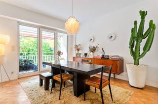 Located in a prime spot next to Antwerp’s Stadspark, this exceptionally elegant apartment is situated on the first floor of the charming Residence Longchamps. It offers a unique blend of grandeur, authentic details, refined design, and modern comfort.The sunny front terrace offers a beautiful, green view of the City Park and is one of the property’s greatest assets. Inside, the oak herringbone parquet flooring, original radiator cabinets with brass grilles, and restored wardrobes create a timeless ambiance. An authentic hatch from the former service elevator serves as a special piece of history.The stylish Boffi kitchen features a natural stone countertop and high-quality Gaggenau appliances, complemented by a Bosch American-style refrigerator and an integrated dishwasher. Adjacent to the kitchen are a storage room with a balcony and a separate laundry room.The hallway leads to three bedrooms, a walk-in closet, a guest restroom, and a bathroom. The master bedroom is situated in a quiet spot at the rear and has its own terrace and direct access to the bathroom. The second bedroom charms with its French-style built-in closet doors.The apartment also features a private attic room and a basement storage unit.Residence Longchamps dates back to 1957 and exudes the elegant atmosphere of Antwerp’s bygone era. A rare urban residence for those who appreciate authenticity, design, space, and an exceptional location.