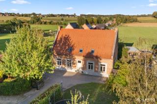 Charming country house featuring four rooms, playroom attic, cellar, carport with EV charging station, spacious terrace, and a lovely garden with a garden shed, situated on a plot of 12a 01ca in the heart of Binkom.<br /><br />Anyone dreaming of a historic farmhouse from 1785 where authentic character meets contemporary comfort will find their dream home here in the heart of Binkom. This fully renovated country house combines excellent energy efficiency with a 12a 01ca plot and a delightful, private outdoor space.<br /><br />The well-maintained entrance hall with guest toilet and cloakroom immediately invites you to explore further. You enter the spacious L-shaped living room, which is flooded with natural light and offers a tranquil view of the garden. Adjoining is the fully equipped kitchen with all conveniences, handily flanked by a large, practical storage and laundry room. Furthermore, the ground floor features a nicely decorated relaxation area that is perfectly suited as an office or fourth bedroom.<br /><br />Via the staircase, you reach the spacious, central night hall on the first floor, offering additional possibilities for an open workspace. Here you will find three comfortable bedrooms and a modern bathroom equipped with both a bathtub and a walk-in shower. The top floor houses a brilliantly finished playroom attic with a separate storage room, ideal for growing children. In addition, the property features an authentic vaulted cellar.<br /><br />A spacious 52m² terrace extends around the house, from where you can enjoy the lovely, well-kept garden in complete privacy. In the front garden, the large renovated bakehouse catches the eye, serving excellently as a workshop, practice room, or play area. The picture is complete thanks to the carport with an EV charging station and various parking spaces on private property.<br /><br />This property was completely renovated around 2012 and therefore offers plenty of modern comfort. This results in an energy-efficient home (label B - 158 kWh/m²/year); the electrical installation is compliant and the house is asbestos-safe.<br />Oil-fired central heating. Rainwater cistern and groundwater well present, as well as a water softener.<br />A modern home in an authentic, historic building. In absolute top condition and immediately ready to move into.<br /><br />Located in the centre of Binkom with a very easy connection to the centre of Lubbeek (3 km): shops, supermarket, school, childcare, restaurants, etc. are all easily accessible. Moreover, "Het Gouden Kruispunt" is approximately 5 minutes away.<br />There is also an excellent traffic connection to Leuven, Tienen, Aarschot, and Diest.<br />The E40 motorway access (Boutersem) or the approach to Aarschot is 15 minutes away.
