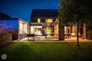 Op een gunstige en vlot bereikbare ligging in Putte bevindt zich deze exclusieve, stijlvol vormgegeven villa, gelegen op een perceel van 998 m². Een eigendom waar ruimte, licht en verfijning samenkomen in een harmonieus geheel, met alle voorzieningen binnen handbereik.<br /><br />Benieuwd naar deze unieke woonbeleving? Ontdek de woning hier via onze cinematische vastgoedfilm!<br /><br />Bij het betreden van de woning wordt u verwelkomd in een lichtrijke inkomhal die meteen de toon zet: stijlvol, doordacht en tot in de puntjes afgewerkt. Hier vindt u tevens een apart gastentoilet, een praktische berging en een op maat gemaakte vestiaire. Aansluitend bevindt zich een eerste bureauruimte, ideaal voor wie wonen en werken naadloos wil combineren. De leefruimte en glaspartijen laten het daglicht rijkelijk binnenstromen en creëren een mooie connectie met de buitenomgeving. De sfeervolle zithoek met gashaard nodigt uit tot ontspannen avonden in alle comfort. Daarnaast beschikt het gelijkvloers over een tweede bureauruimte en een patio, die zorgen voor extra licht en een open, aangenaam ruimtegevoel binnen het open/closed concept van de woning.<br />De leefkeuken beschikt over een indrukwekkend keukeneiland, kwalitatieve toestellen en een hoogwaardige afwerking. Deze elementen maken van deze ruimte een droom voor elke levensgenieter. Hier is bovendien ruim plaats voor een gezellige eethoek met zicht op de tuin. Een plek waar koken, tafelen en samenzijn centraal staan.<br />Ook buiten wordt het luxeverhaal moeiteloos doorgetrokken. Het overdekte terras is voorzien van een open haard zodat u het hele jaar door kan genieten van lange, sfeervolle avonden. Aan alles is gedacht: praktische opbergruimte, een authentieke pizzaoven en een prachtig aangelegde tuin die rust en privacy uitstraalt. Het zwembad, de sauna en de bijhorende douche maken van dit geheel een wellnessbeleving. Op het gelijkvloers bevindt zich bovendien een volwaardige praktijkruimte met aparte ingang en sanitaire voorzieningen. Perfect voor een vrij beroep of zelfstandige activiteit.<br /><br />De eerste verdieping geeft toegang tot vier volwaardige slaapkamers, waaronder een master suite met en-suite dressing. De stijlvolle badkamer is uitgerust met een lavabo, inloopdouche en een vrijstaand ligbad. Eén van de slaapkamers biedt via een vaste trap toegang tot de zolderverdieping, wat extra mogelijkheden creëert. Ook op vlak van energie en technologie voldoet deze woning aan de hoogste standaarden. Met een EPC-label A, 36 zonnepanelen, geïntegreerde muziekinstallatie, alarmsysteem en een conforme elektrische keuring bent u hier volledig klaar voor de toekomst.<br /><br />Kortom, een uitzonderlijke en zeldzame opportuniteit voor wie op zoek is naar een exclusieve, energiezuinige villa met praktijkruimte, vier slaapkamers en een sublieme buitenbeleving in Putte. Contacteer ons voor meer informatie via 0472/22 12 41 of bezoek www.boonstravastgoed.be.<br /><br />Bijzonderheden:<br />- 292 m² bewoonbare oppervlakte<br />- Praktijkruimte met aparte toegang<br />- Hoogwaardige afwerking en architectuur<br />- Energiezuinig (EPC-label A) met 36 zonnepanelen<br />- Zwembad, sauna en buitenbeleving op topniveau