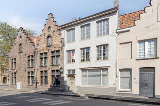 In het hart van de historische binnenstad van Brugge bieden wij dit charmante en karaktervolle pand te koop aan. Gelegen in de directe nabijheid van de "Gouden Driehoek", geniet u hier van een uitzonderlijke woonlocatie waar rust en cultuur samenkomen. Een van de absolute troeven van dit huis is de volledig vernieuwde keuken, die voorzien is van moderne apparatuur en hoogwaardige materialen. Daarnaast beschikt de woning over een gunstig EPC-label C, wat een mooie energieprestatie garandeert voor een pand in de stadskern. Indeling (ca. 99 m² netto bewoonbare oppervlakte):Gelijkvloers:- ruime inkomhal met apart toilet- woonkamer met authentieke schouwEerste verdieping:- hal- woonkamer- keuken Tweede verdieping- hal- badkamer- twee slaapkamersDerde verdieping:- volwaardige zolderruimte via VlizotrapDe bereikbaarheid van dit pand in Brugge is uitstekend. U bevindt zich op wandelafstand van lokale speciaalzaken, gezellige horeca en het openbaar vervoer. Een huis kopen in deze regio betekent kiezen voor een zorgeloze levensstijl in een bruisende omgeving. De woning is beschikbaar voor bewoning vanaf 01/01/2027Bestuursmaatregelen in het maatregelenregister: nee