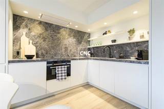 Just renovated penthouse with large sun terraces 20 meters walking distance from the seawall and beach. With side sea view!The apartment was completely renovated this year!Layout: entrance hall with guest toilet. Bright living space with open kitchen sitting area and direct access to the sun terrace (South-West orientation). Fully equipped open kitchen, two double bedrooms each with their own shower room. Large rear terrace (morning sun). All rooms have fitted wardrobes.Private cellar in the building.Need more information or want to schedule a visit? Contact Nathalie Colpaert on 0495/62 18 81 or via mail info@immocnc.be.