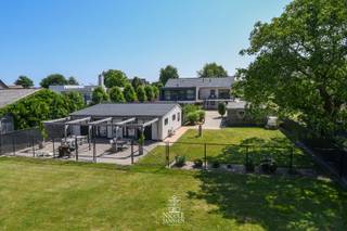 Op een vlot bereikbare ligging nabij Aldeneik vind je deze instapklare villa, ideaal voor wie houdt van modern design en hoog wooncomfort. <br />De woning is doordacht opgebouwd rond volwaardig gelijkvloers wonen, met extra leef- en slaapruimte op tuinniveau.<br /><br />=> Ligging <br />De woning is gelegen dichtbij het mooie en groene Aldeneik, een geliefde buurt nabij het centrum van Maaseik. U woont op wandelafstand van de Maas, omringd door natuur en fietsroutes, met winkels, scholen en horeca vlot bereikbaar.<br /><br />=> Leefniveau op het gelijkvloers<br />- Ruime en lichte leefruimte door de grote raampartijen<br />- Leefkeuken met kwalitatieve afwerking en zicht over de tuin<br />- Bureelruimte/extra slaapkamer aan de voorzijde<br />- Volwaardige masterbedroom met complete dressing en ensuite badkamer<br />- Vloerverwarming, airco en veel natuurlijk licht<br /><br />=> Volwaardig appartement op tuinniveau<br />- Tweede leefruimte met keuken<br />- Twee ruime slaapkamers <br />- Badkamer, wasplaats en bergruimtes<br />- Ideaal voor logees, kinderen, zorg aan huis of hobbyruimte<br /><br />=> Bijgebouw, multifunctioneel te benutten<br />- Ruim bijgebouw met vergaderruimte/eetruimte, toilet en praktische keukenblok<br />- Ruim buitenterras met houten pergola en vrij uitzicht<br />- Perfect voor ontspanning, gasten of professioneel gebruik<br /><br />=> Tuin<br />- Volledig omheind perceel met automatische poort<br />- Verzorgde tuin met open zicht op achterliggende velden<br />- Dubbele carport en fietsenberging<br /><br />=> Waarom dit pand uniek is<br />- Gelijkvloers wonen gecombineerd met volwaardige extra woonentiteit<br />- Energiezuinig met zonnepanelen<br />- Geschikt voor verschillende levensfases<br /><br />=> Indeling<br />- Gelijkvloers: inkomhal, apart toilet, woonkamer, leefkeuken, bureelruimte/extra slaapkamer, ouderlijke slaapkamer, dressing, badkamer <br />- Tuinniveau- tweede woongedeelte: woonkamer, keuken, twee slaapkamers, badkamer, apart toilet, tuinkamer, wasplaats, berging met vaste kastenwand, technische ruimte en extra berging;<br />- Bijgebouw met terras<br />- Dubbele carport <br />- Fietsenberging<br />- Zolder: te bereiken via vaste trap